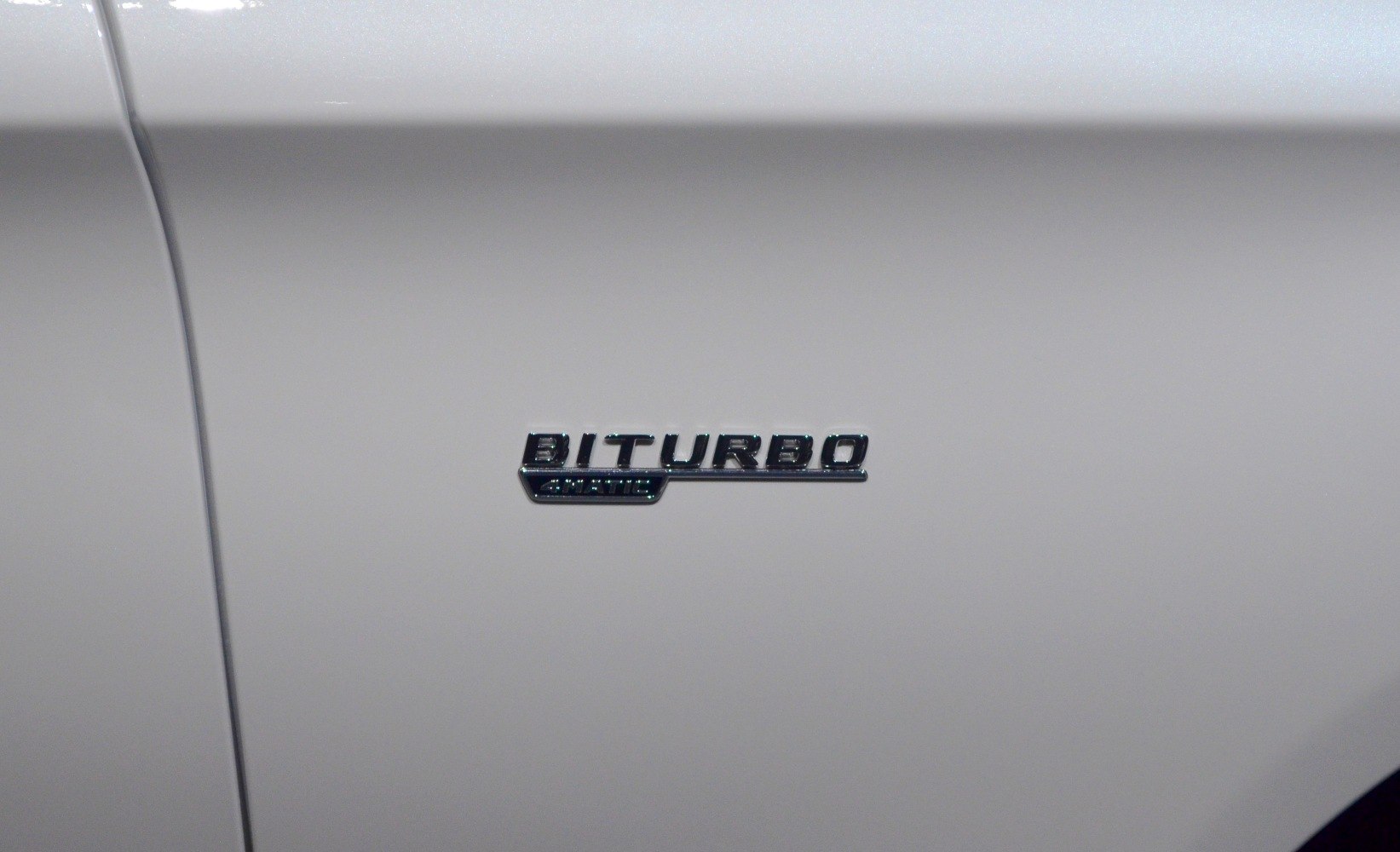BiTurbo emblem badge on white car side panel