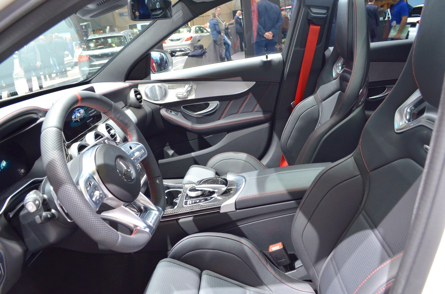 Luxury sport seats with red stitching and AMG steering wheel in modern car interior
