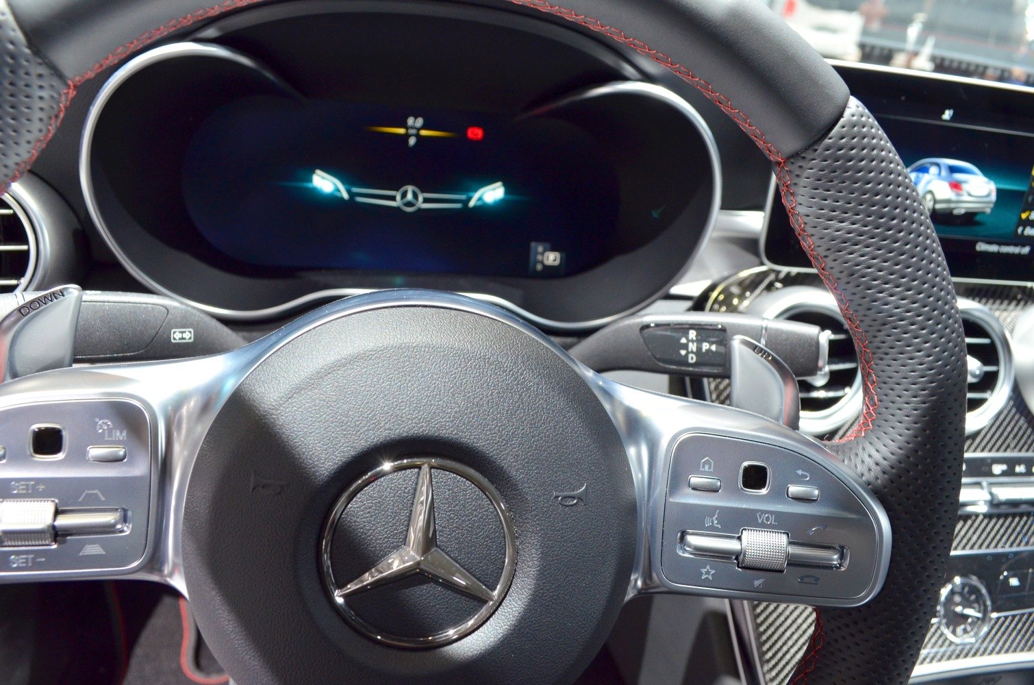 Digital instrument cluster and multifunction steering wheel with red stitching