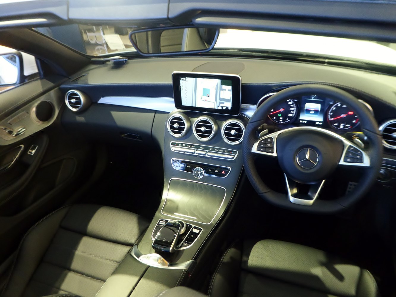 Luxury car interior with dashboard, steering wheel, infotainment screen