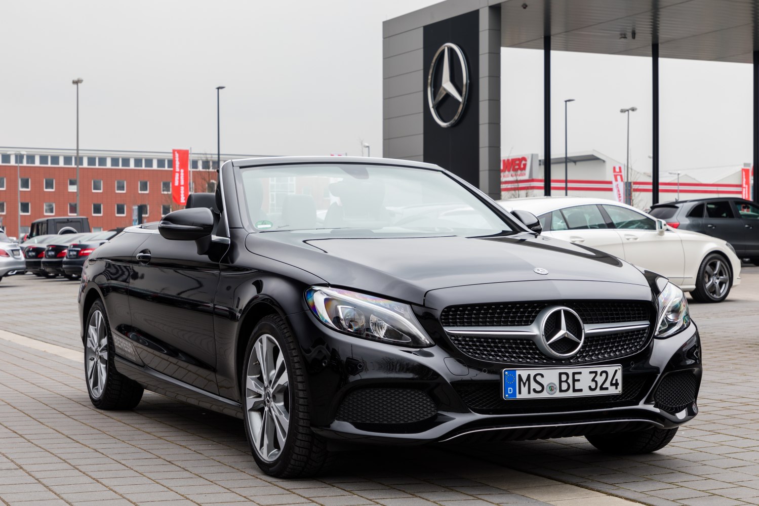 Convertible with sleek front, modern headlights, and grille design