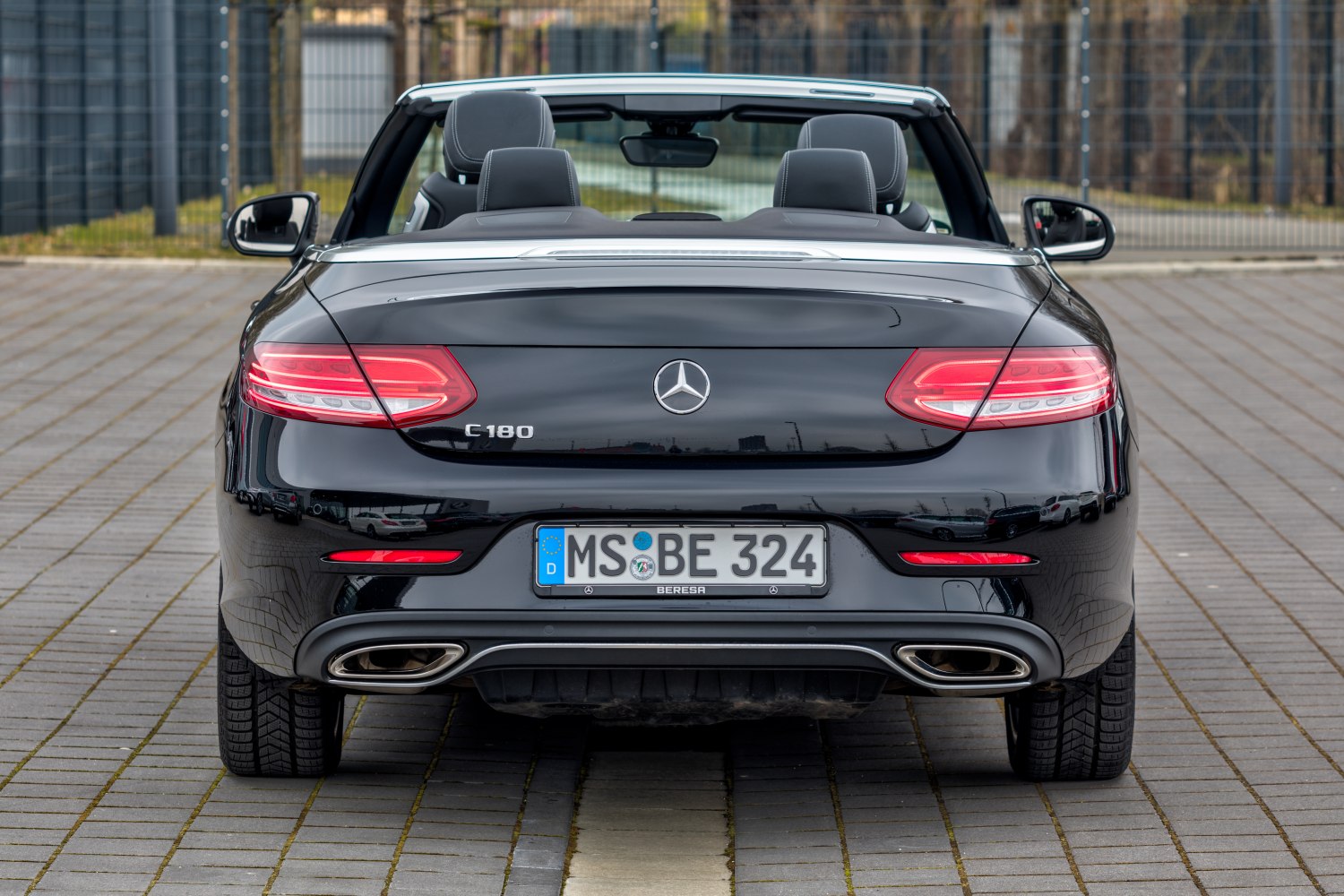 Rear view of a convertible with dual exhaust and LED taillights