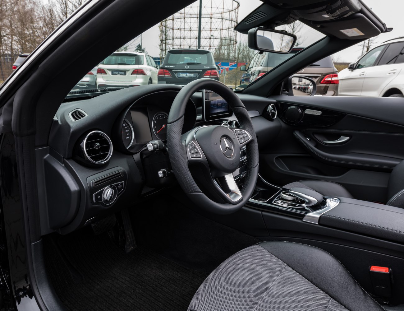 Luxury car interior with steering wheel and dashboard layout