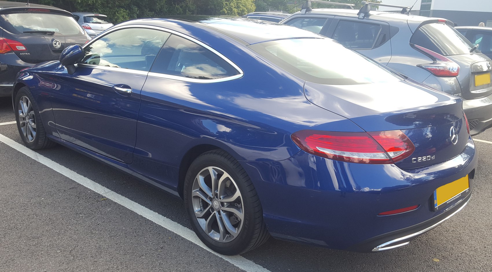 Blue coupe with sleek rear side design and alloy wheels