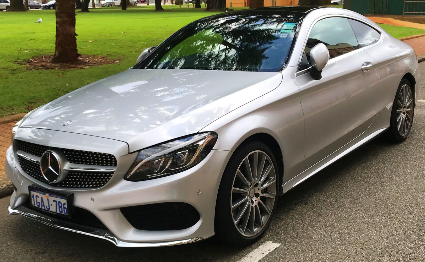 Silver coupe front side view with alloy wheels and sleek aerodynamic lines