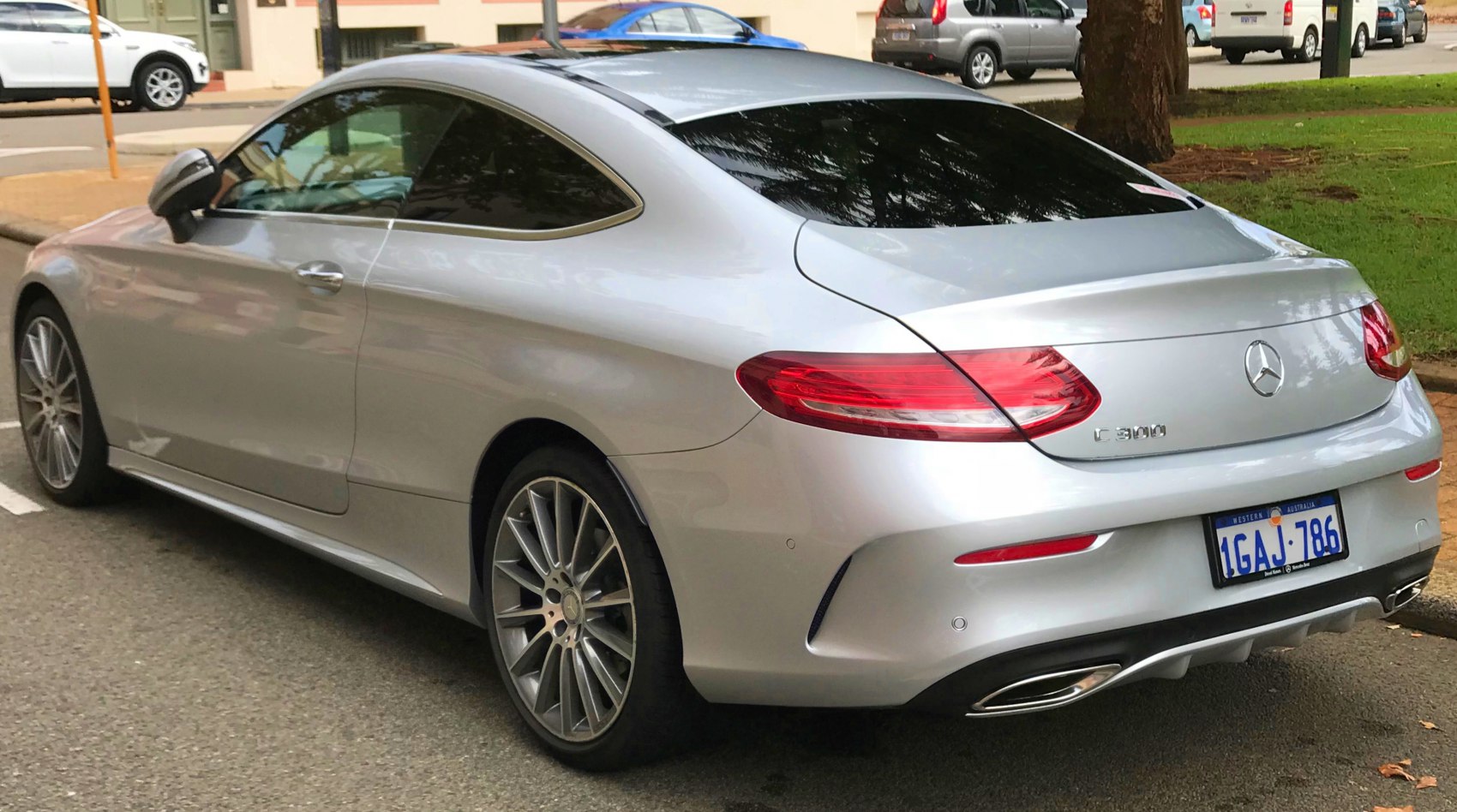 Sleek rear design and tail lights with dual exhaust of a coupe