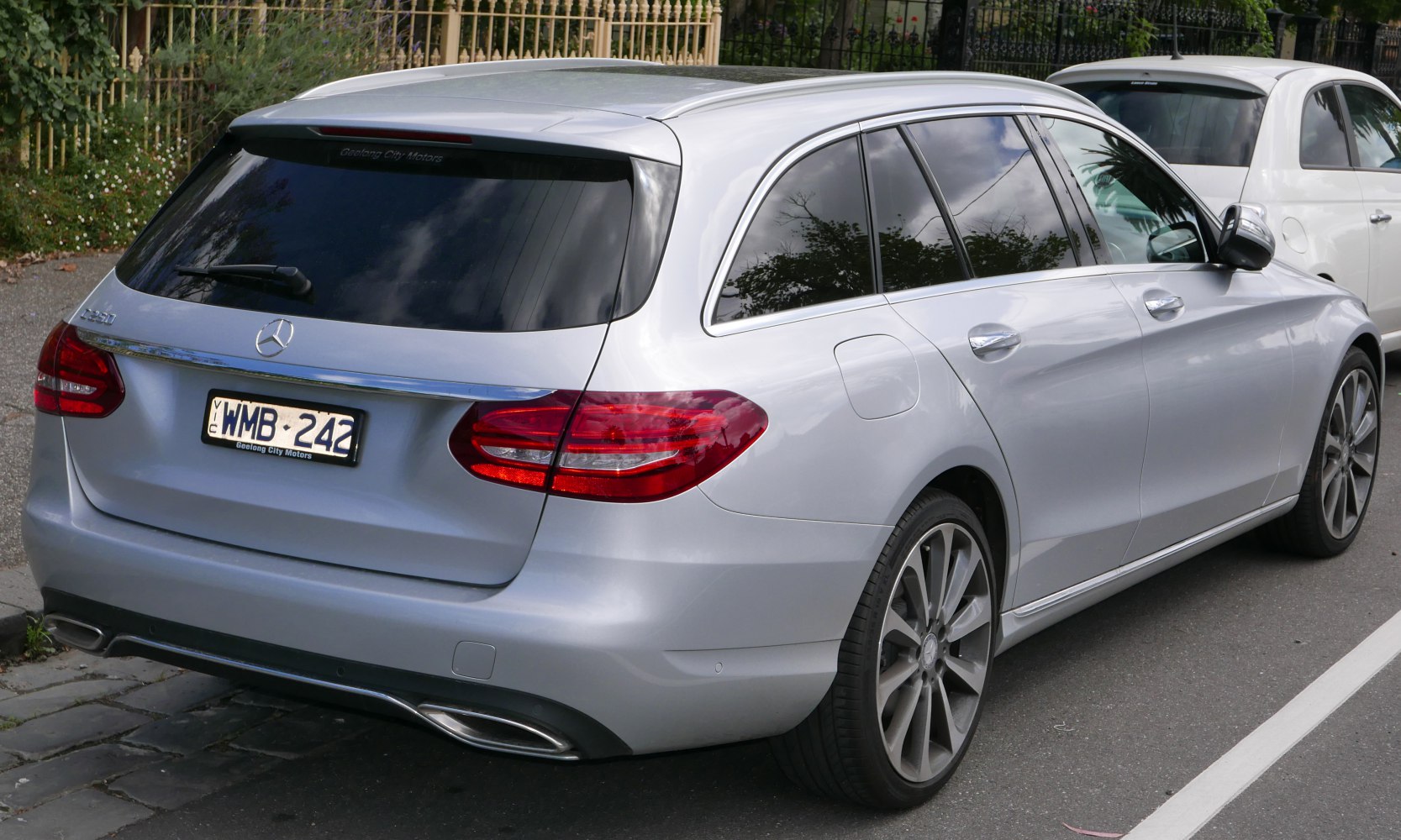 Silver station wagon rear with dual exhaust and prominent taillights