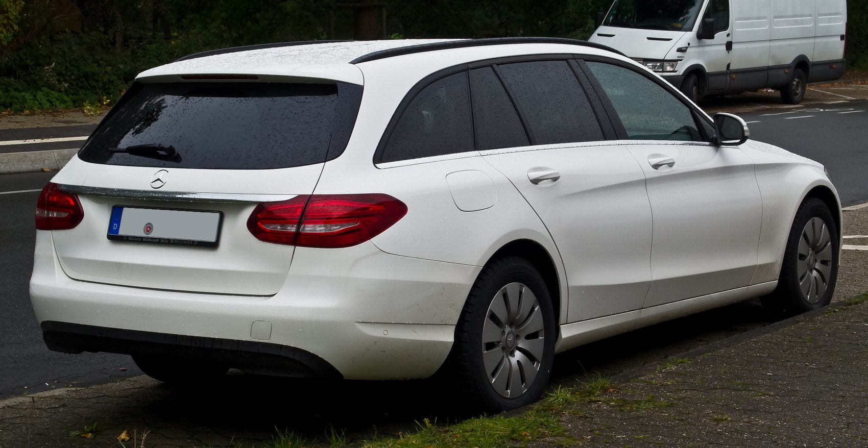 Rear and side view of white station wagon