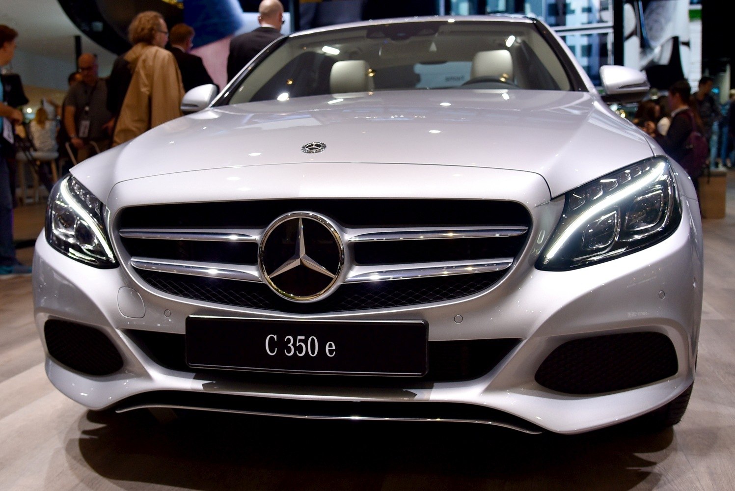 Close-up of car front grille and LED headlights with emblem