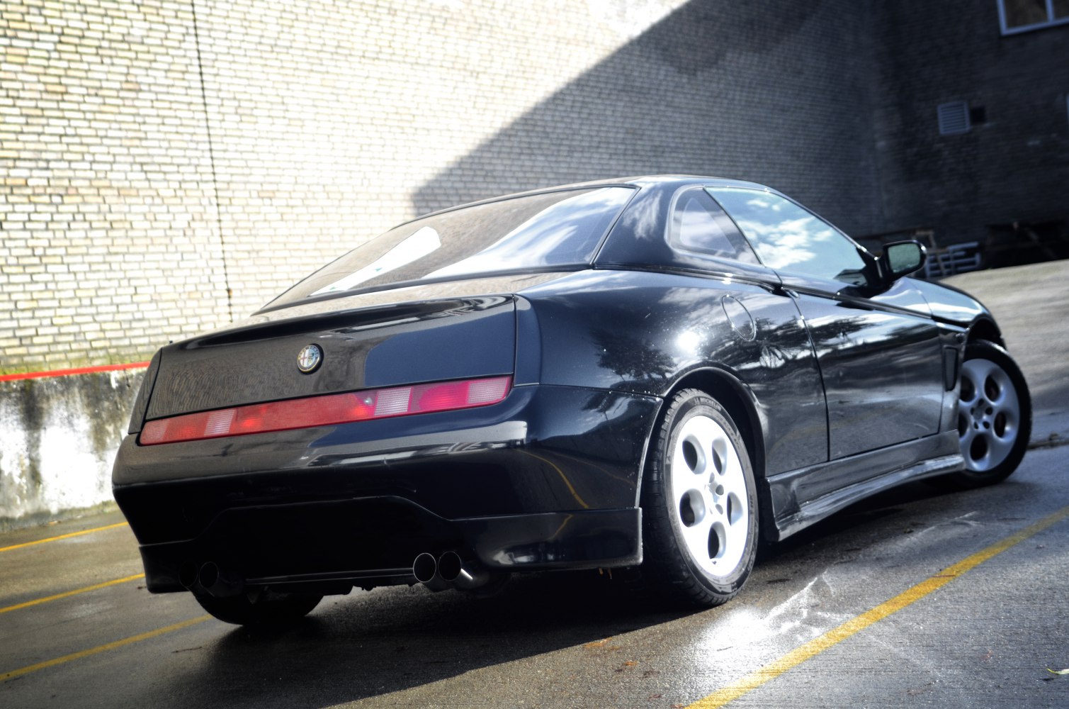 Sleek rear view featuring quad circular tail lights and dual exhaust pipes