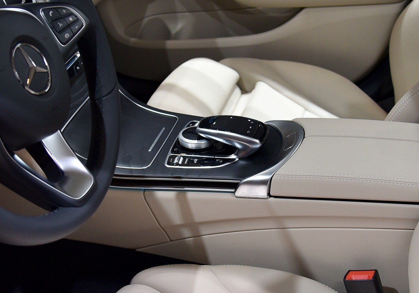 Luxury beige interior with center console and steering wheel control dial
