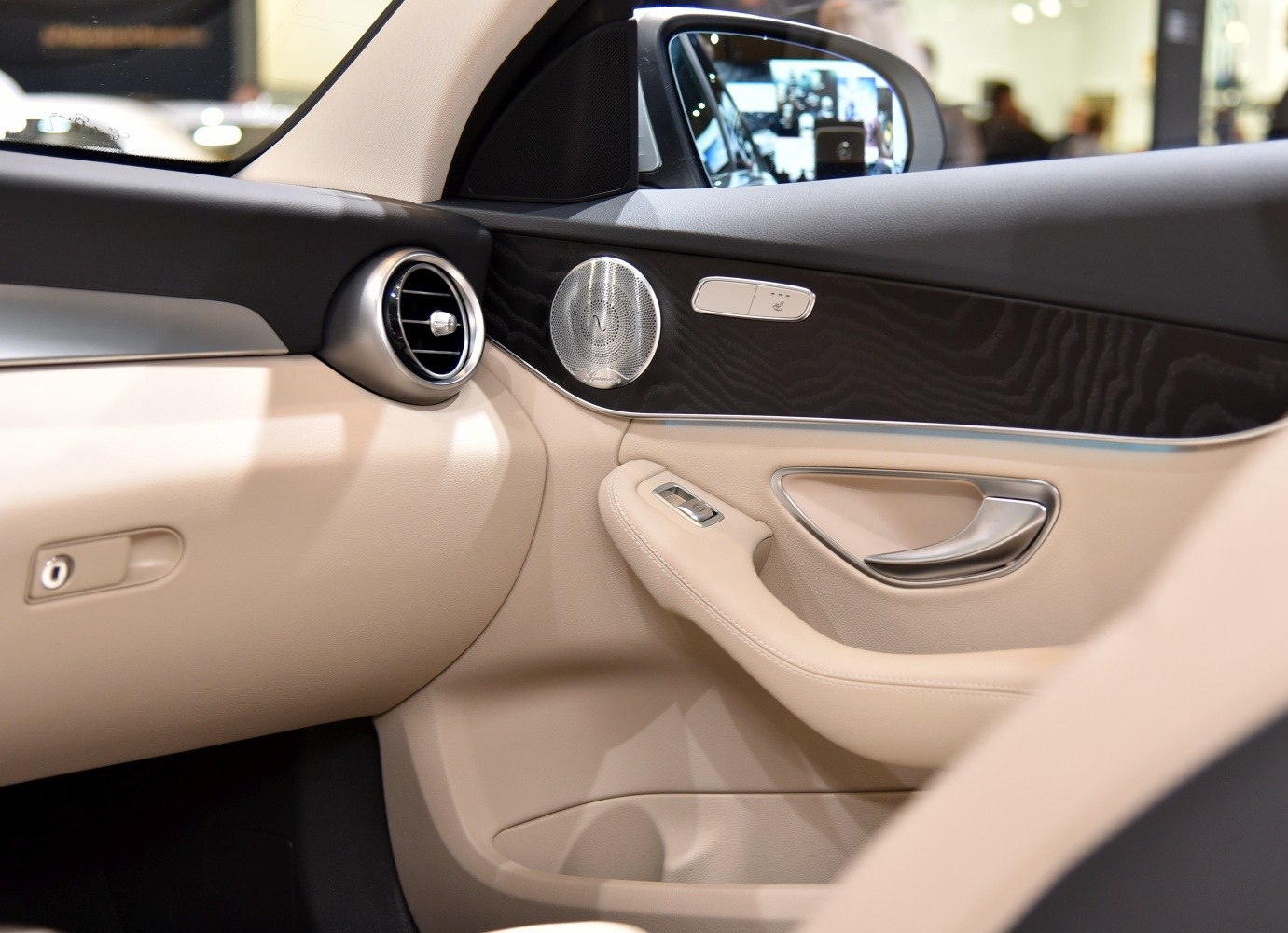Car door interior with premium speaker, air vent, and controls