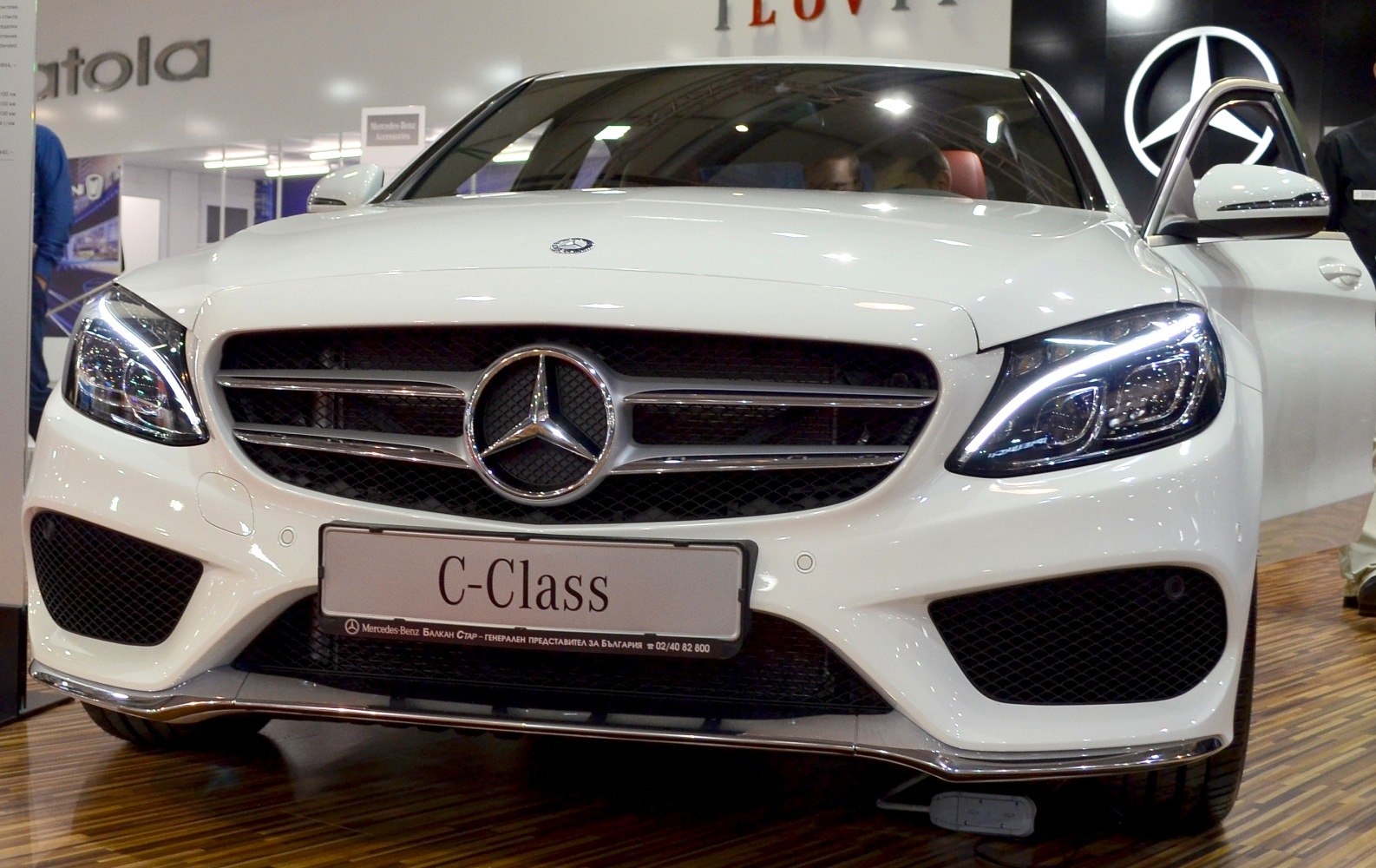 Front grille and LED headlights of a white luxury sedan