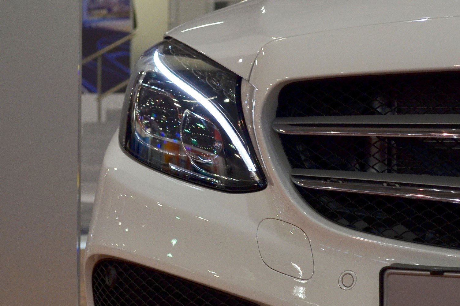 Close-up of front headlight and grille with LED strip lighting