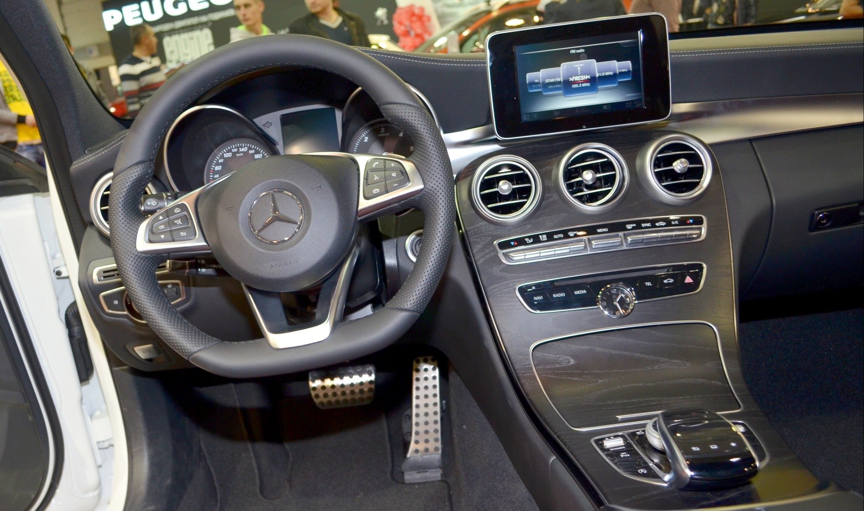 Steering wheel and dashboard with infotainment system and climate controls