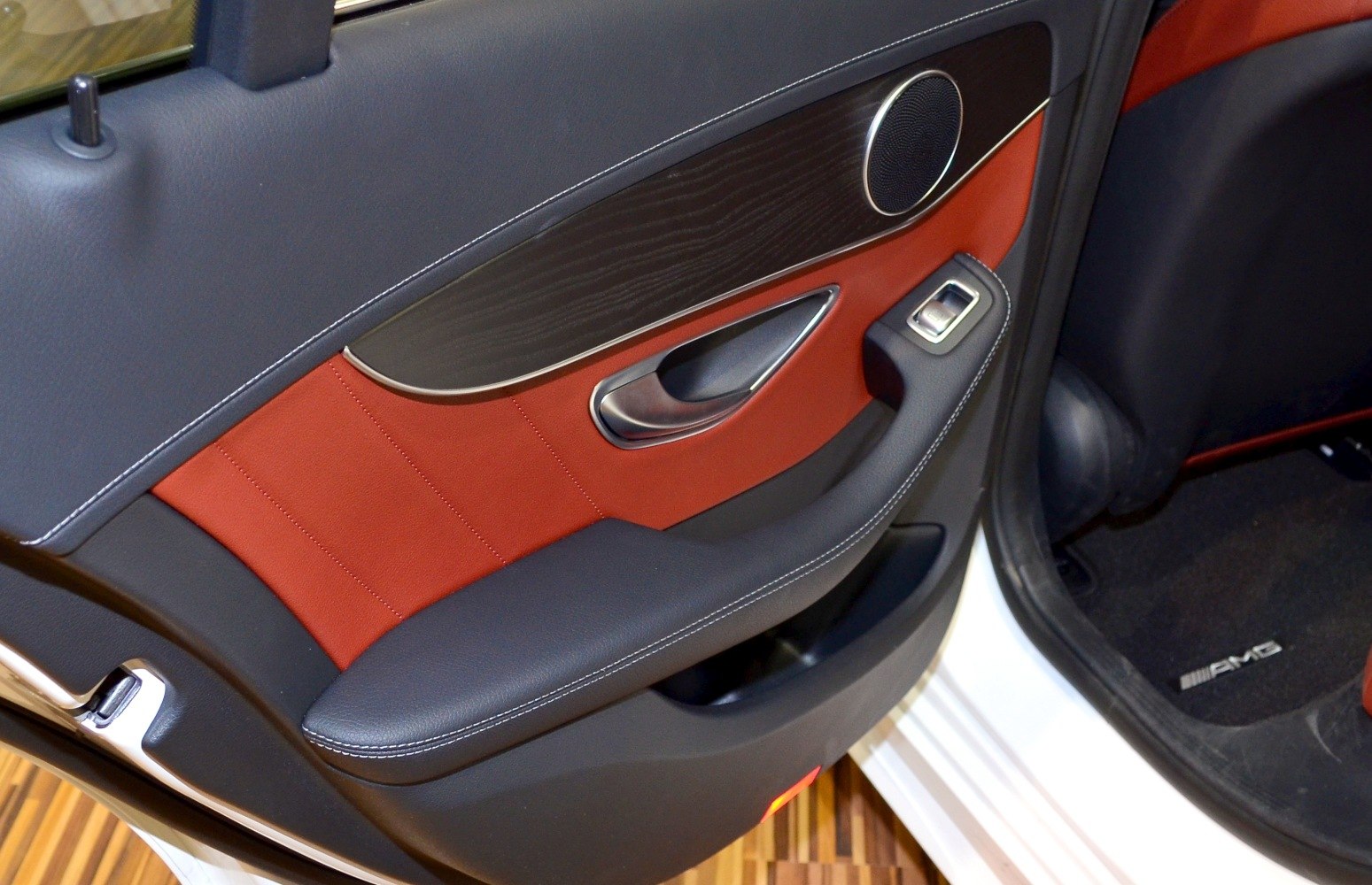 Rear door interior panel with wood trim and leather upholstery