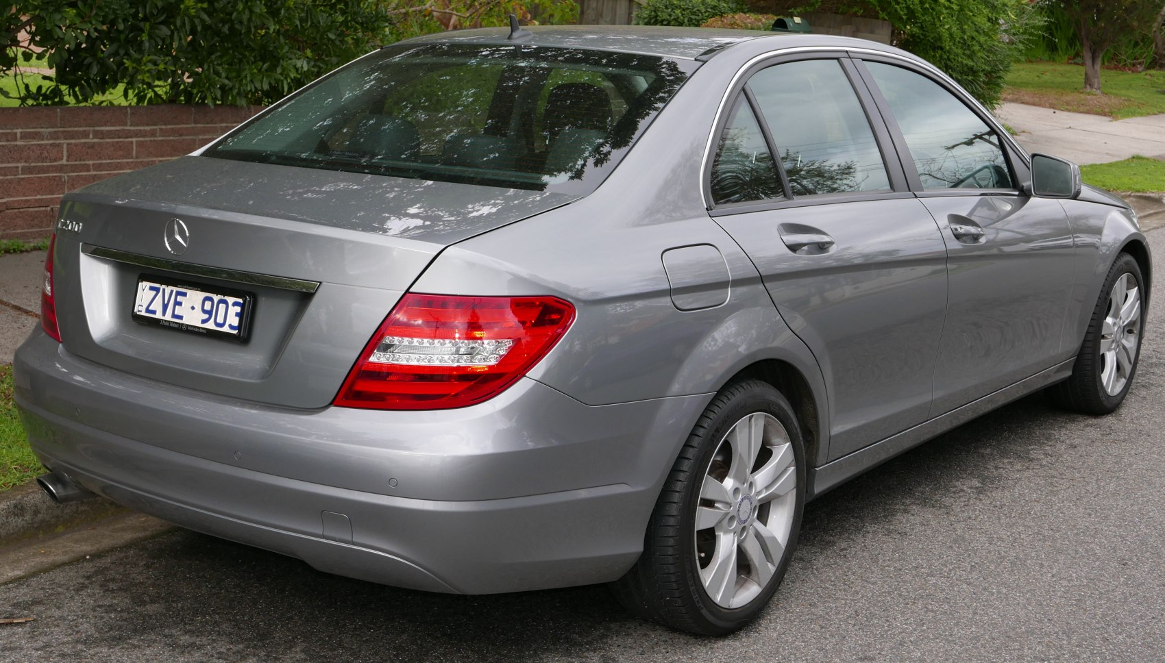 Rear and side view of a silver sedan with LED tail lights and alloy wheels