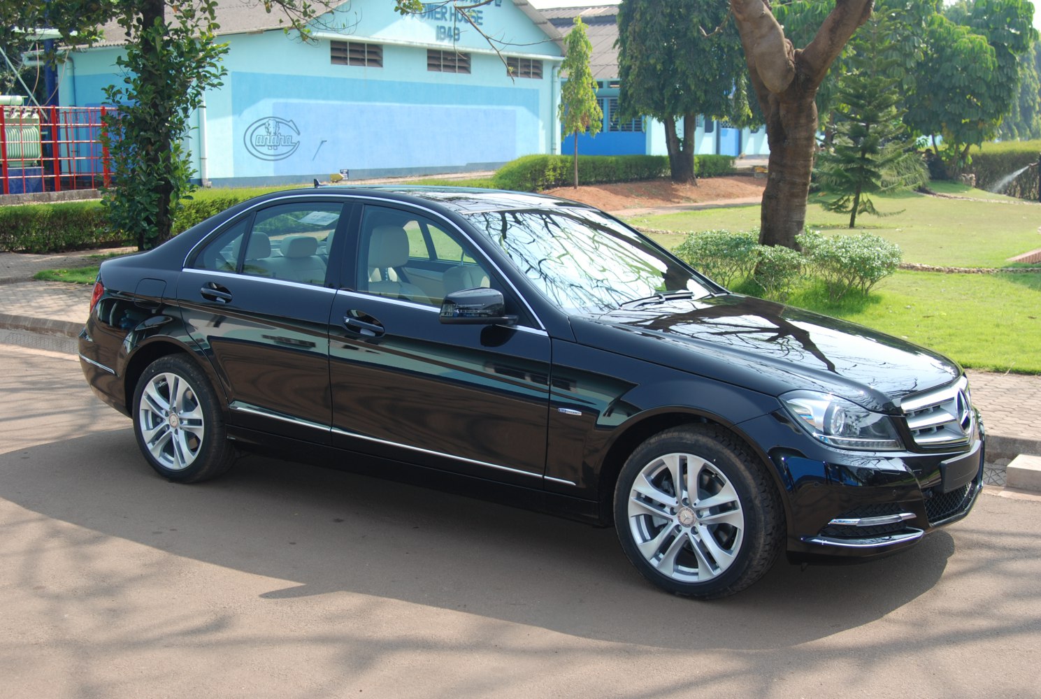 Black sedan with front side profile, chrome trim, alloy wheels