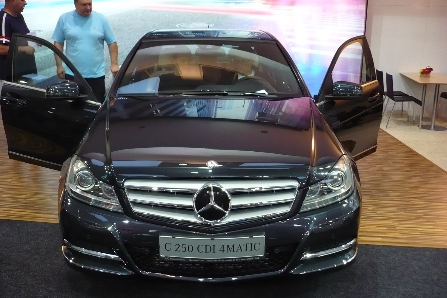 Front view of luxury sedan with grille, headlights, and open doors