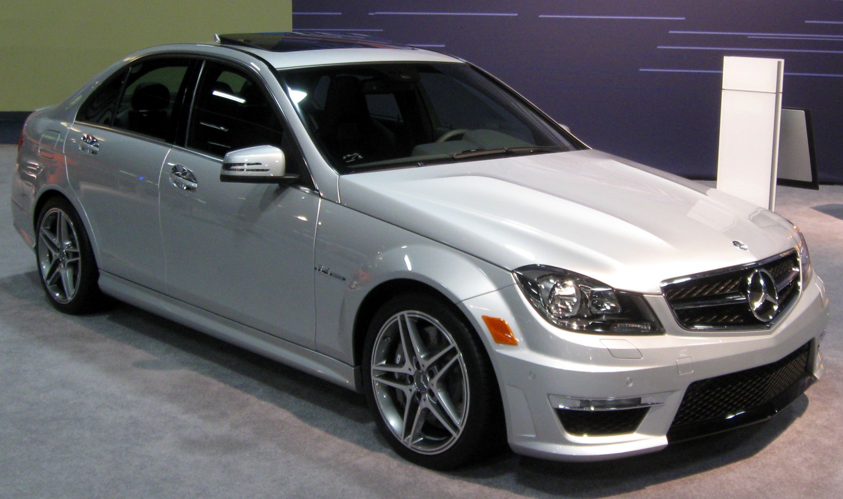 Silver sporty luxury sedan with AMG alloy wheels and enhanced front design