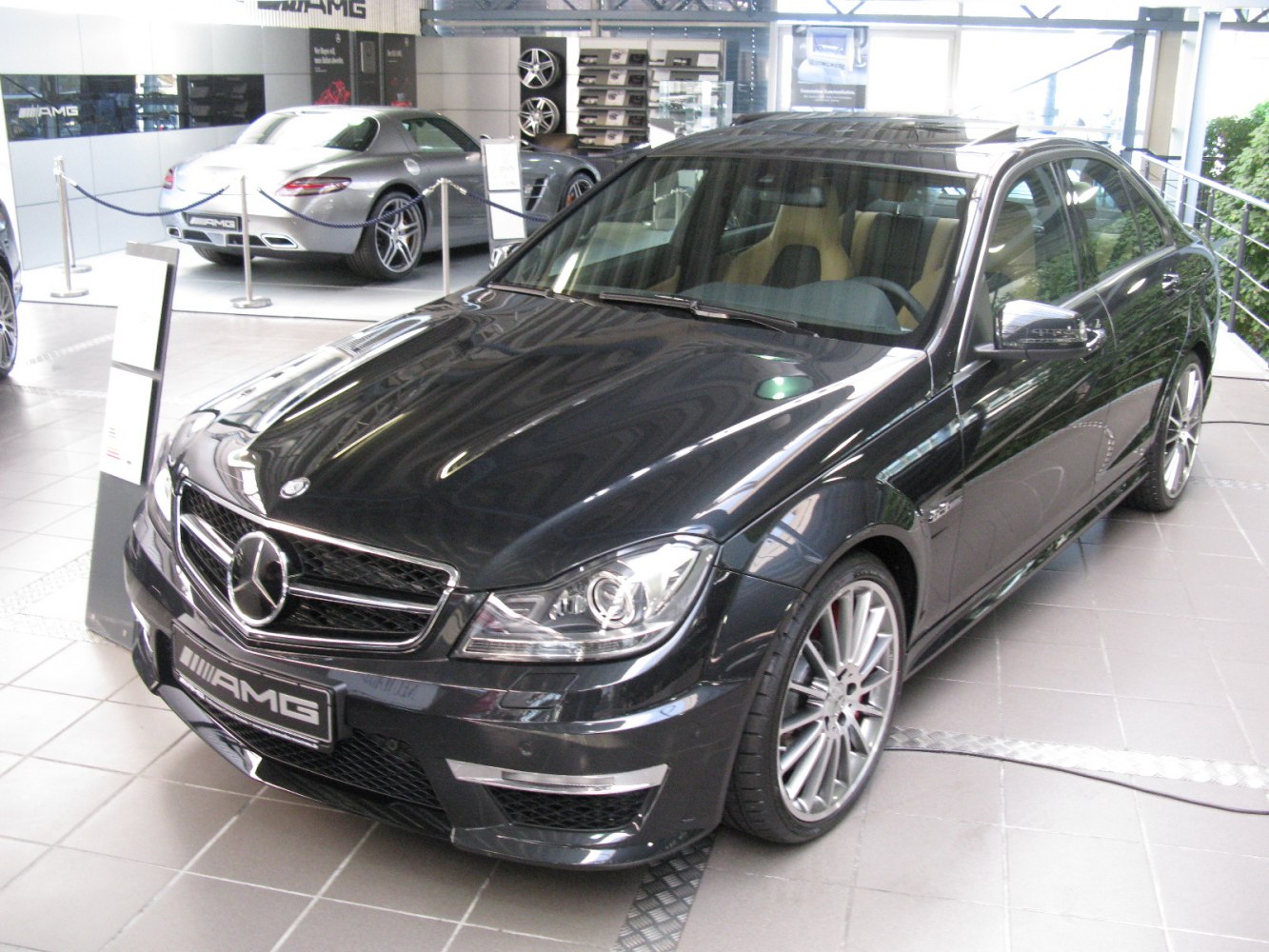 AMG front grille and alloy wheels visible on sporty black sedan