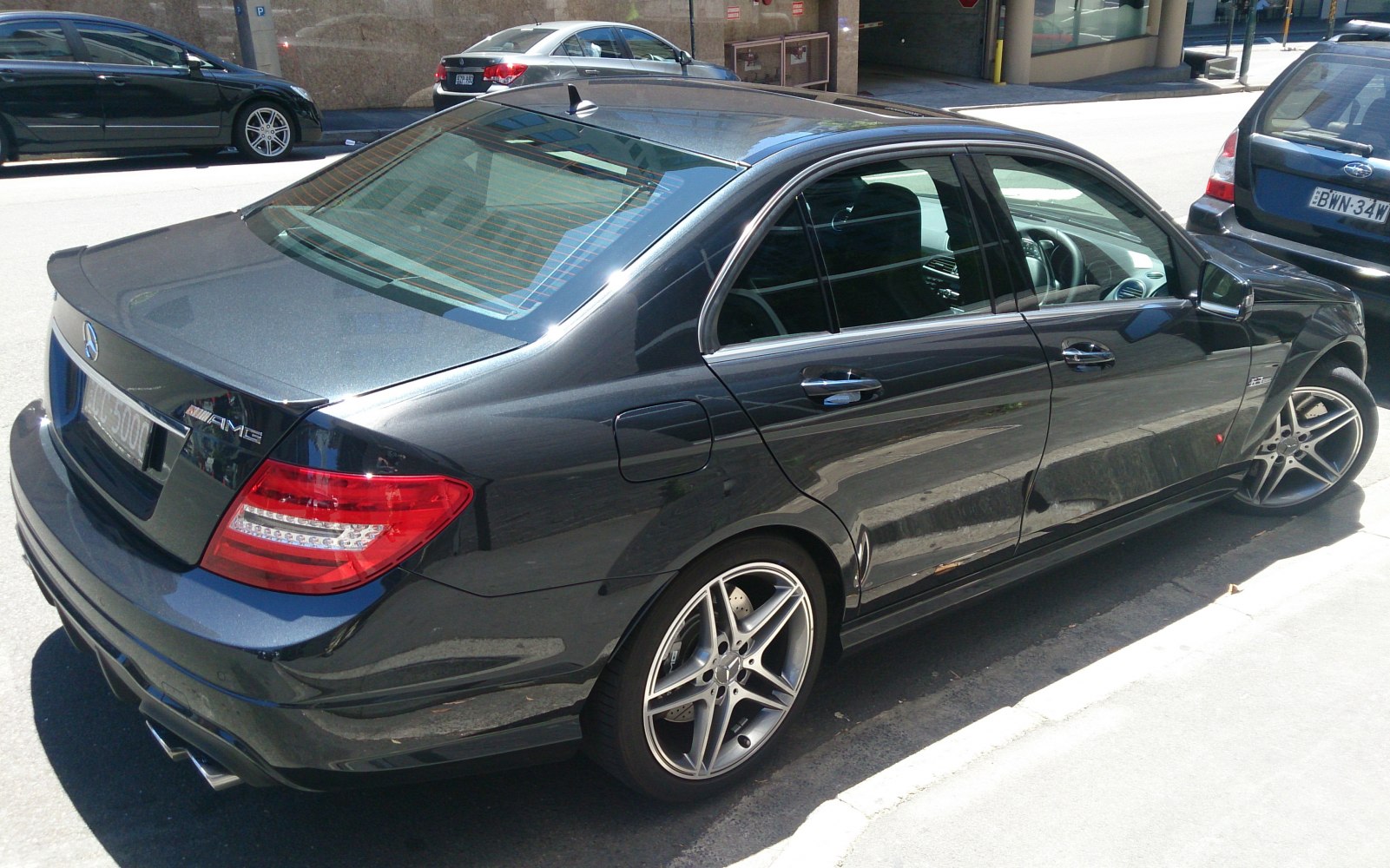 Rear view of sporty sedan with AMG alloy wheels and dual exhaust
