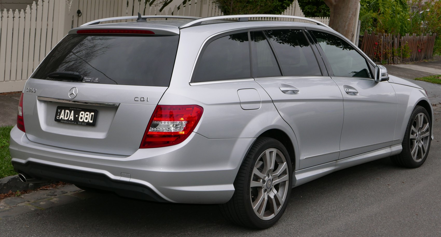 Silver station wagon rear side with roof rails and LED tail lights