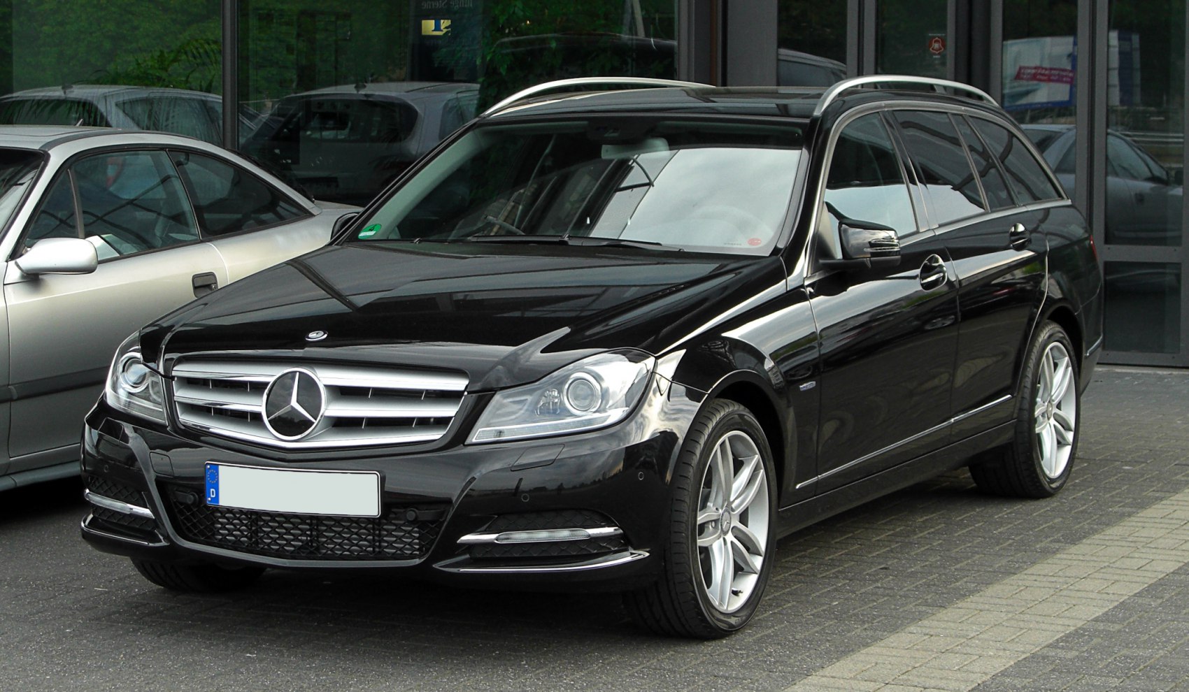 Black station wagon with grille, alloy wheels, and roof rails