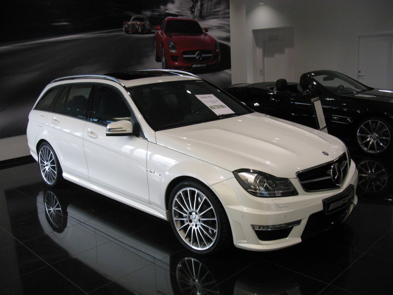 Luxury white station wagon with AMG trim and multi-spoke alloy wheels