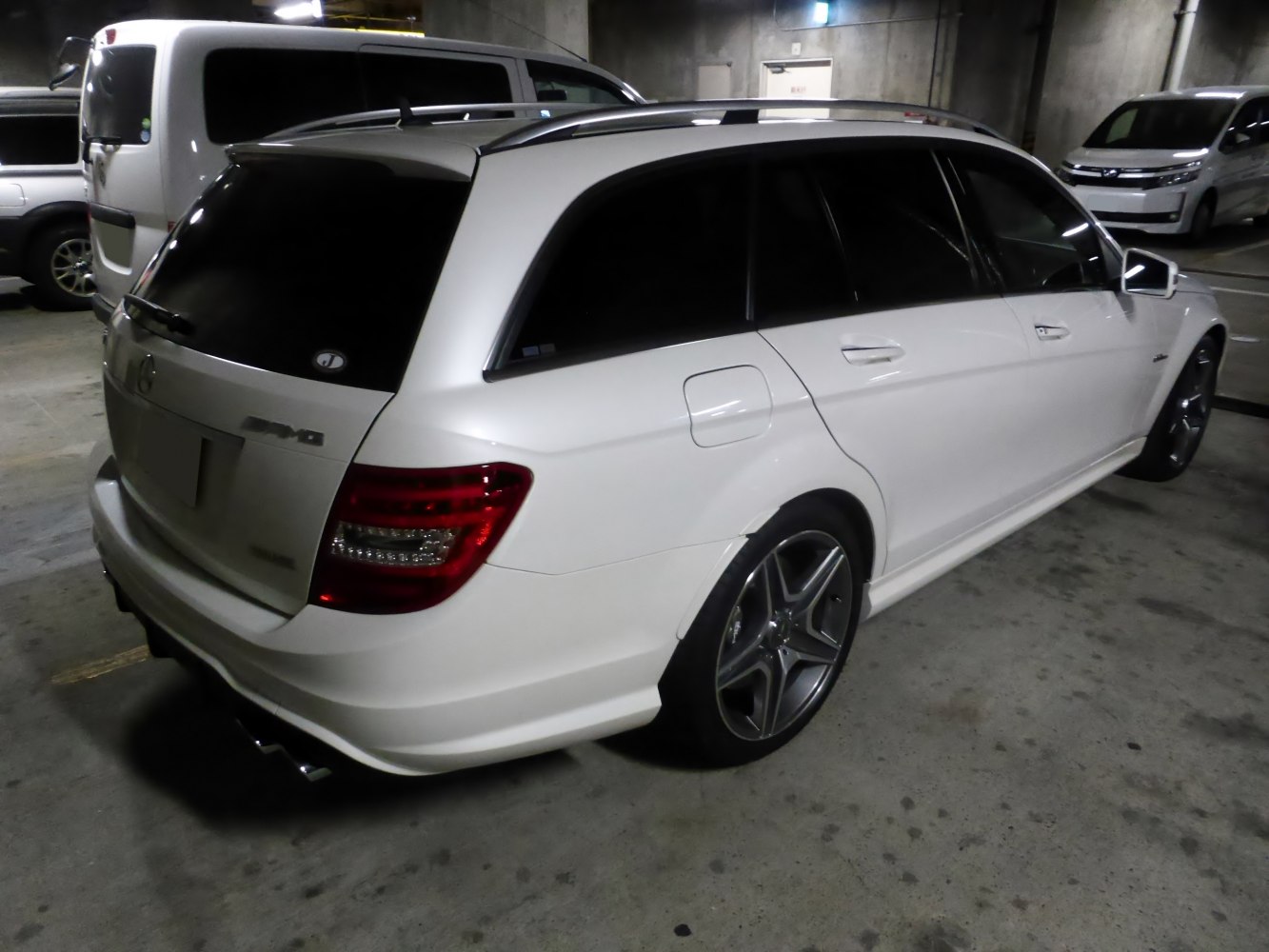 White luxury station wagon with AMG styling and alloy wheels