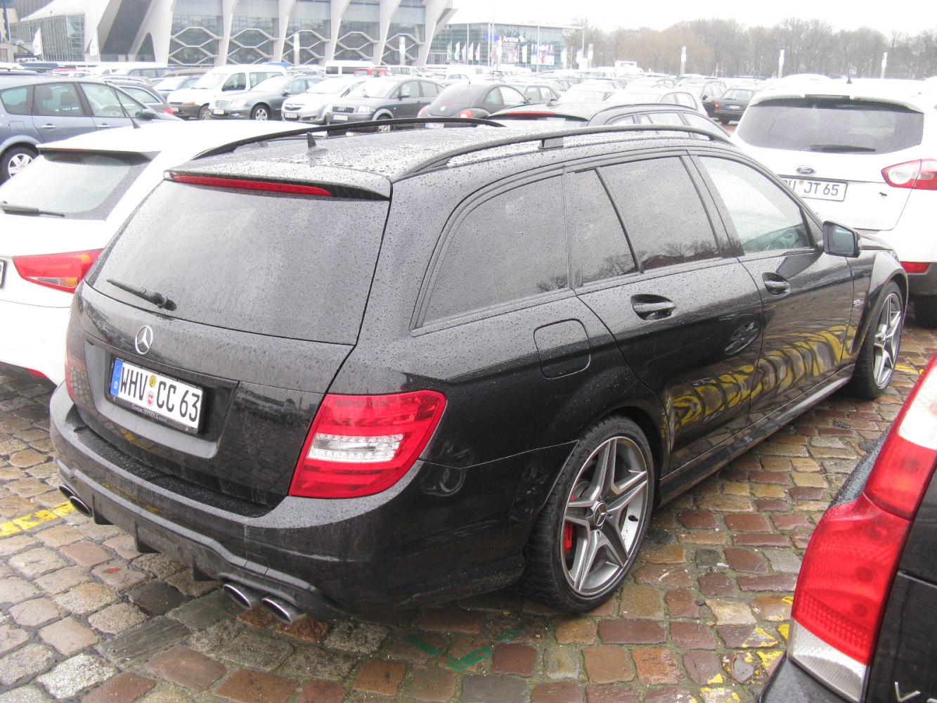 Rear view of black estate with quad exhaust and alloy wheels