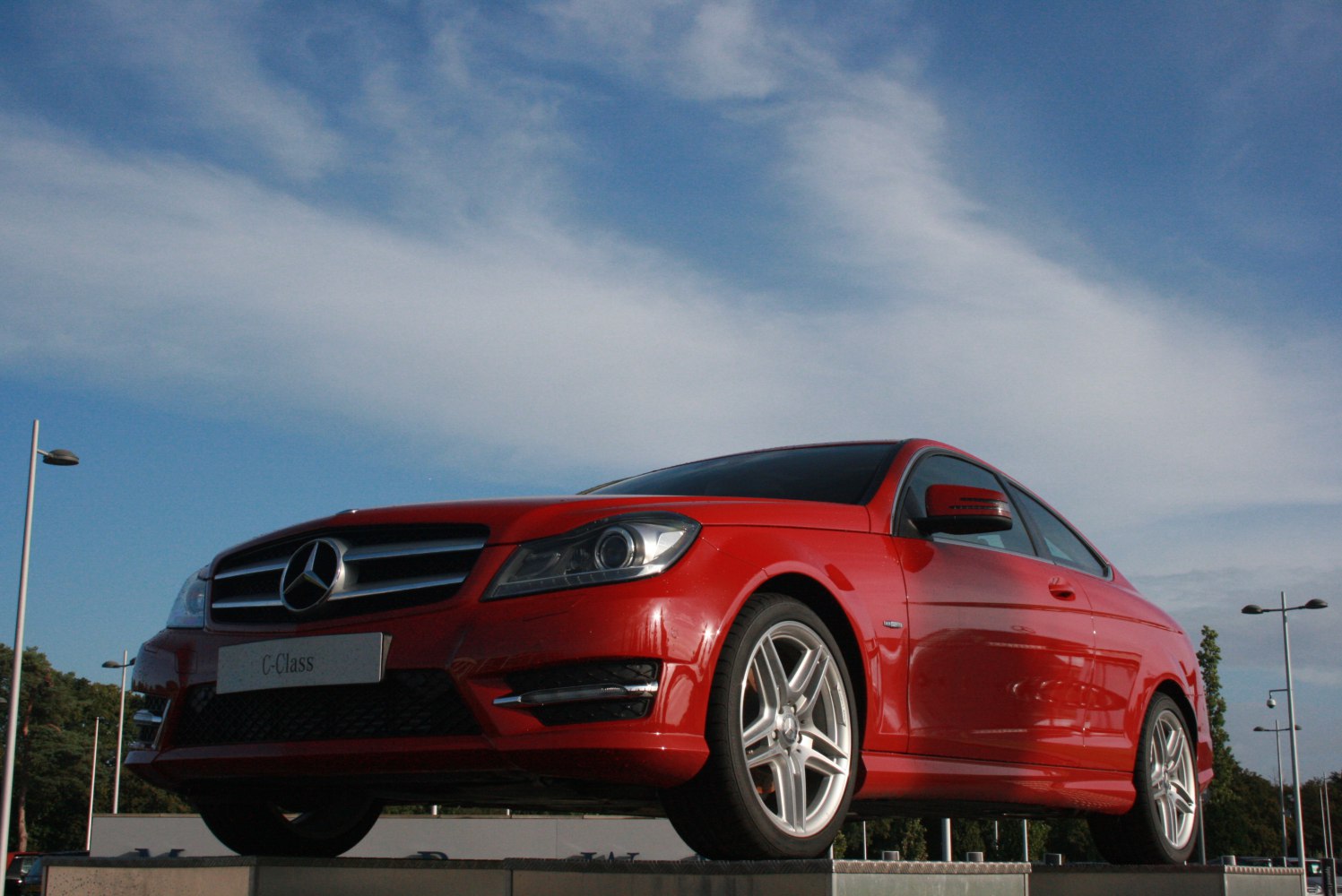 Red coupe with front grille and alloy wheels