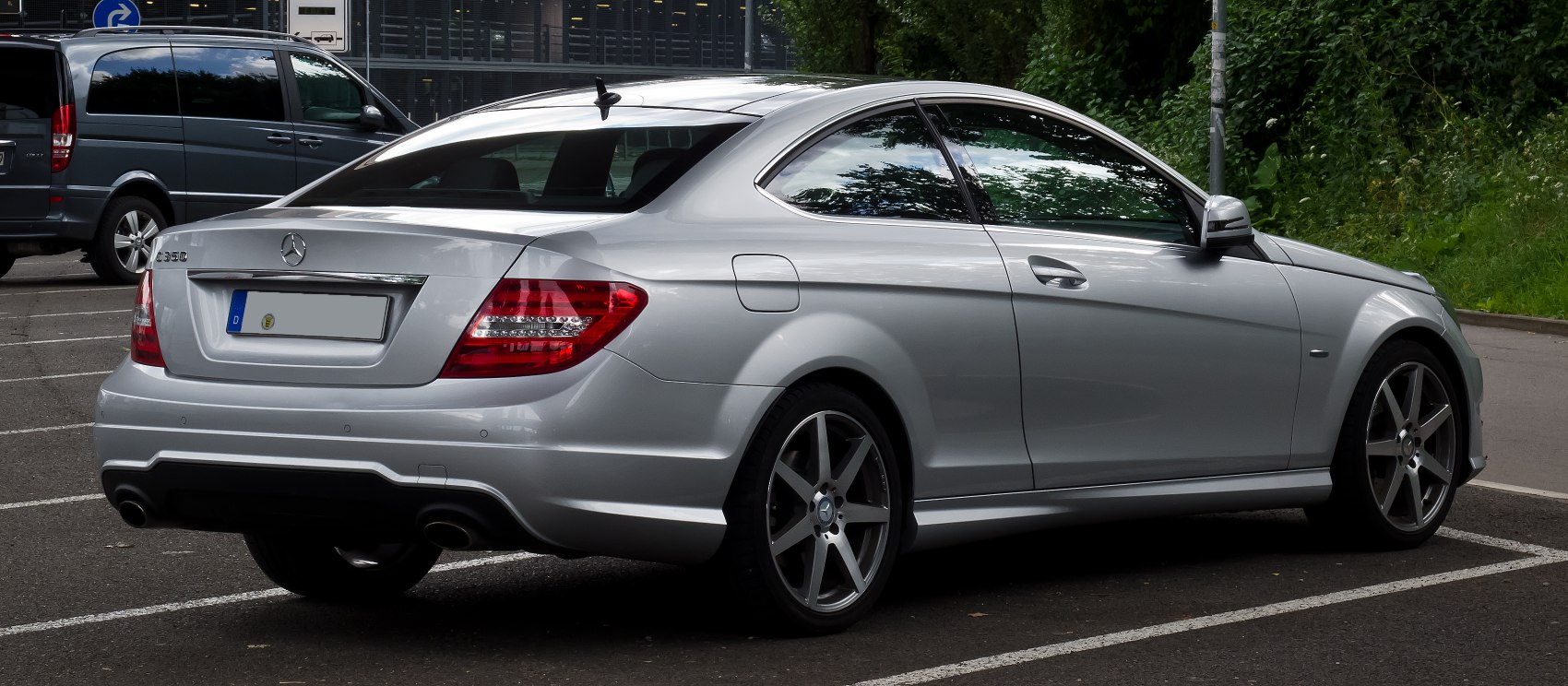 Sleek coupe rear view with dual exhausts and alloy wheels.