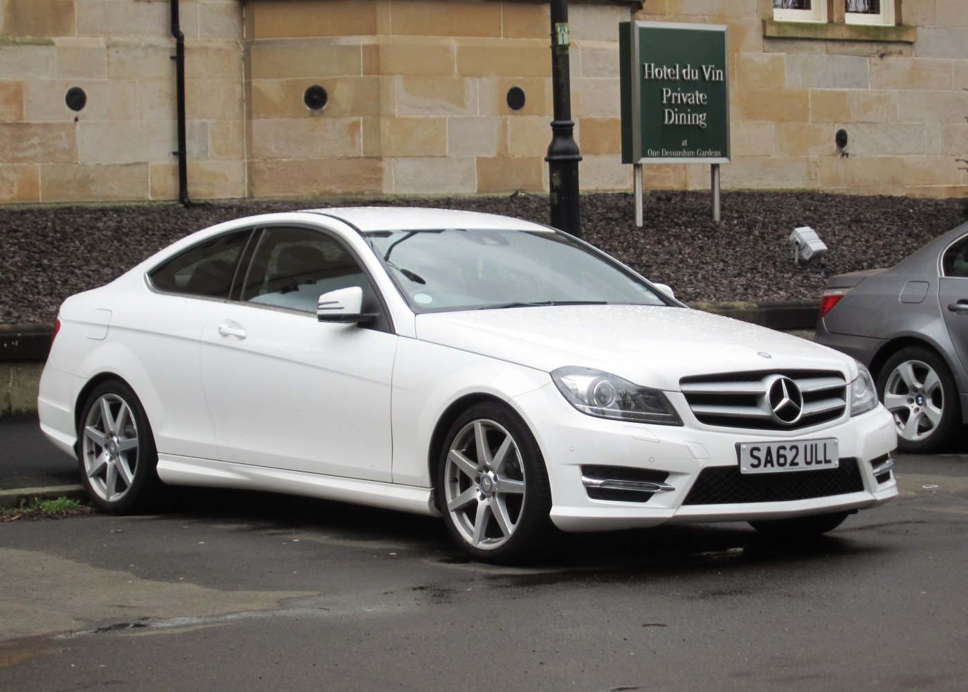 White coupe with sleek front and side profile, alloy wheels