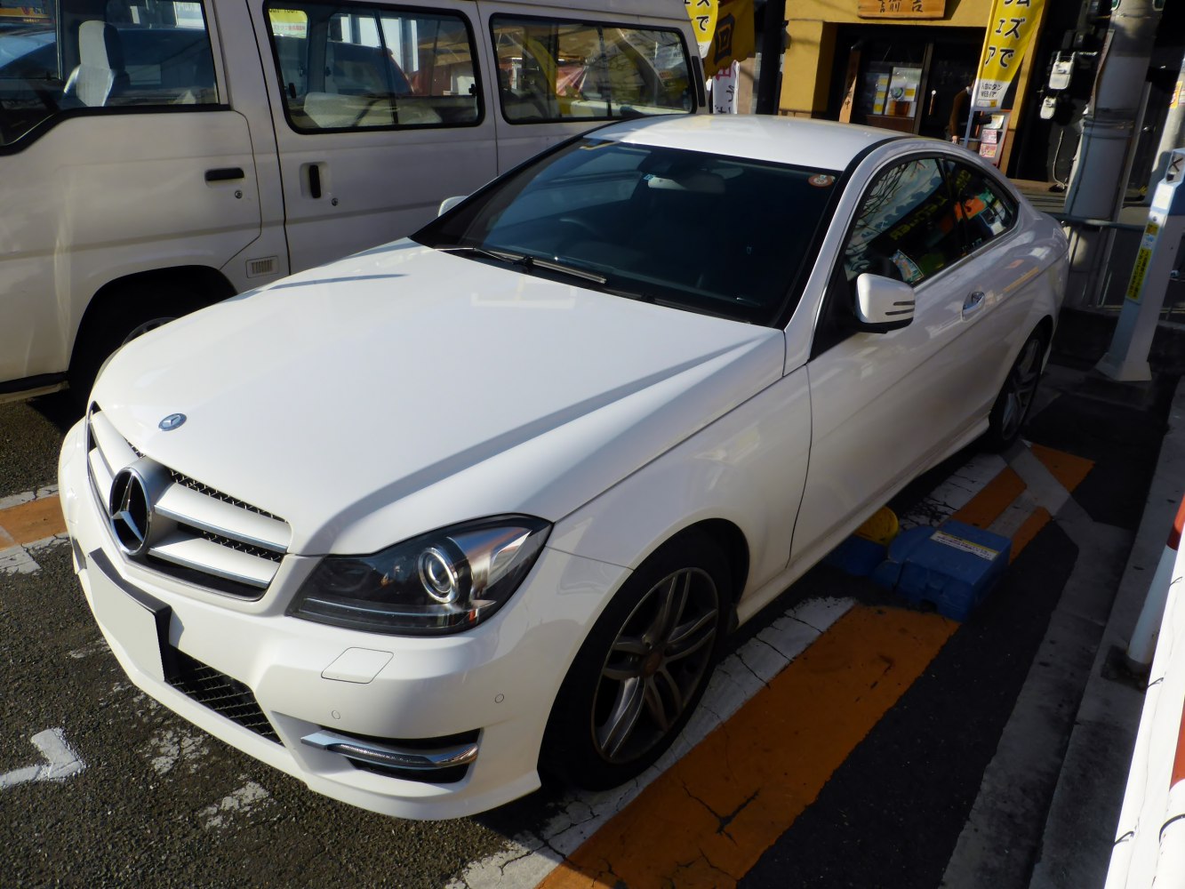 White luxury coupe with aerodynamic headlights and sleek side profile