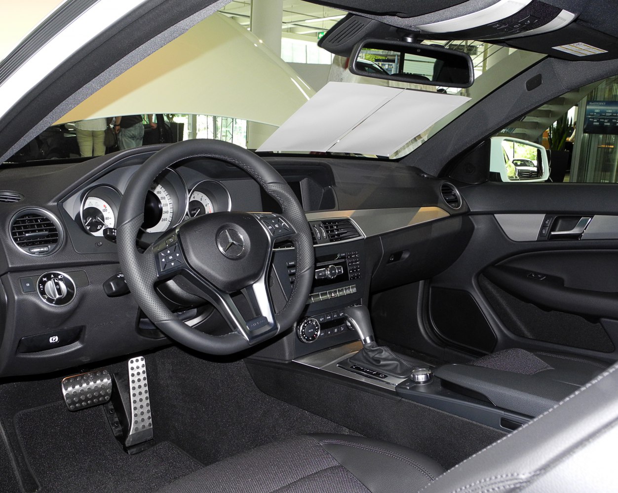 Modern luxury car interior with multifunction steering wheel and sleek dashboard