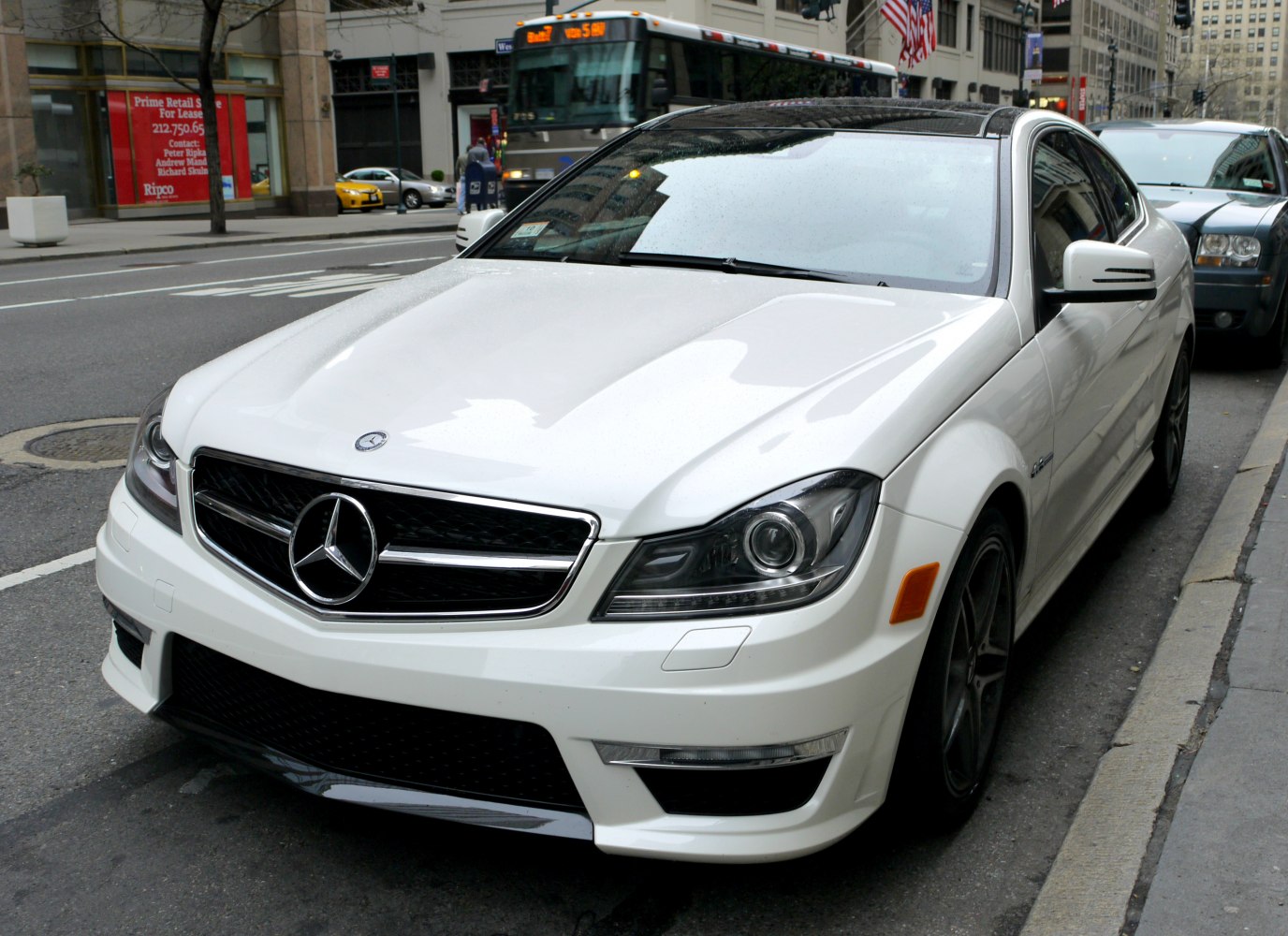 Front view of sleek coupe with sharp headlights and grille