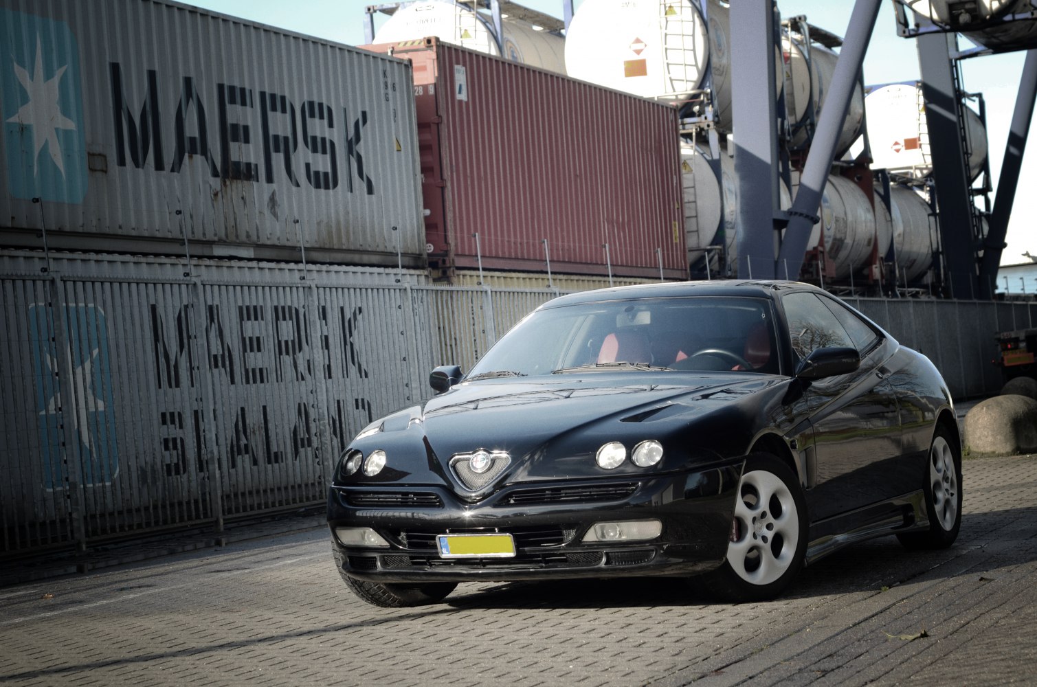 Front view of a sleek sports coupe with quad headlights.