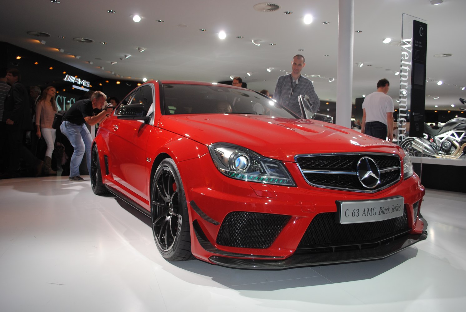 Red coupe with aggressive front design and black alloy wheels