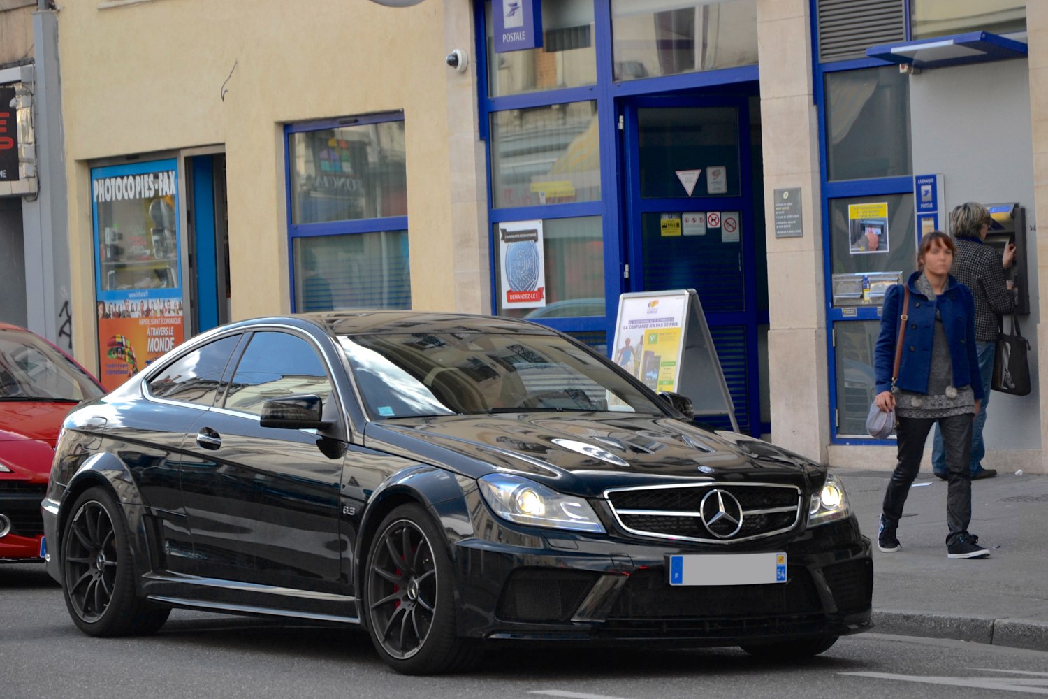 Black sporty two-door coupe with AMG wheels and LED headlights