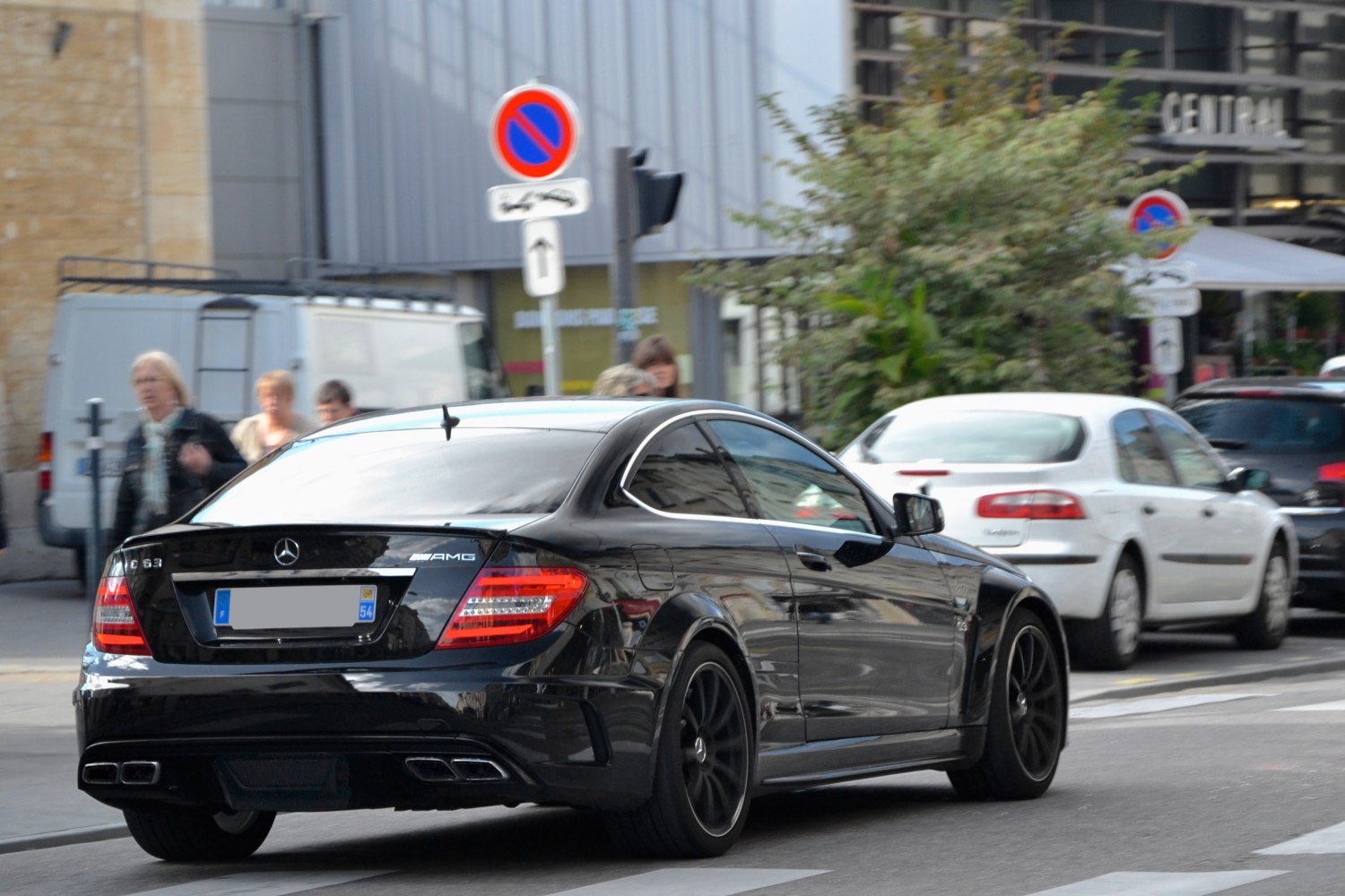 Rear view of black coupe with quad exhausts and tinted windows