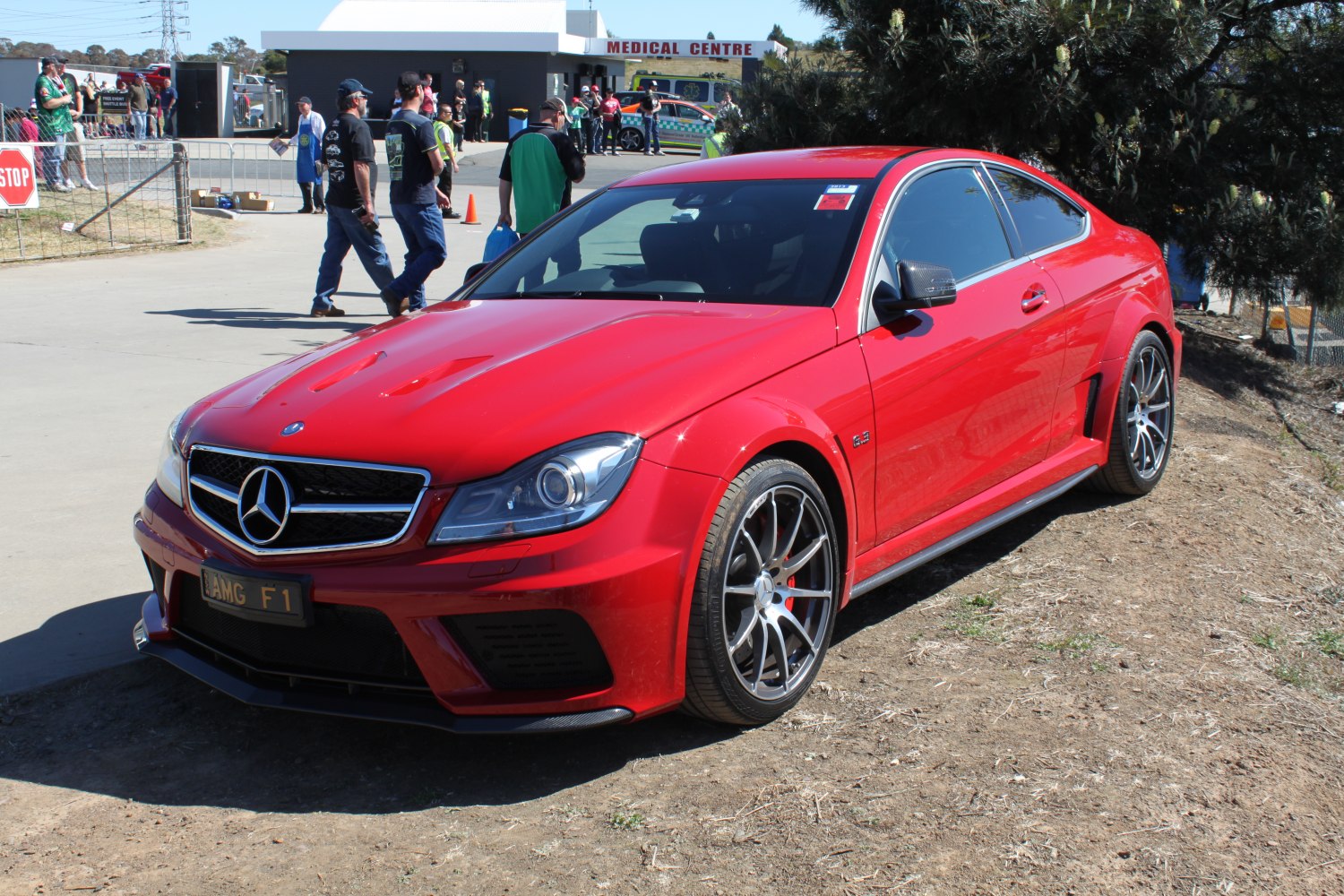 Front three-quarter red coupe with sporty wheels and aggressive front fascia