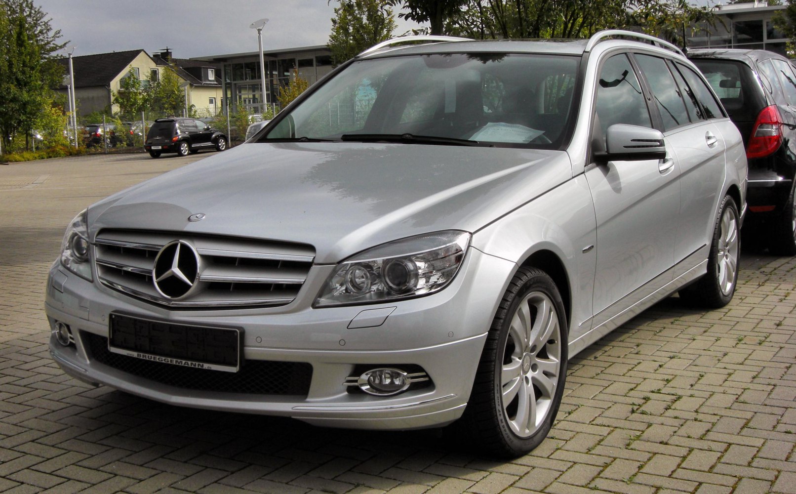 Silver station wagon with LED headlights, alloy wheels, and roof rails