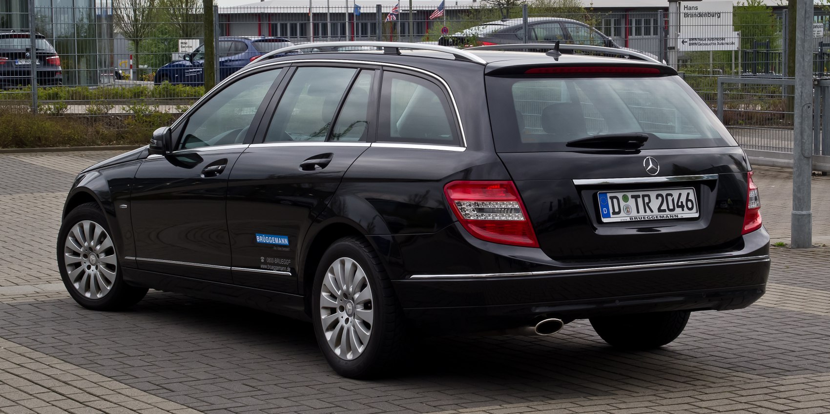 Rear side view of black station wagon with roof rails and alloy wheels