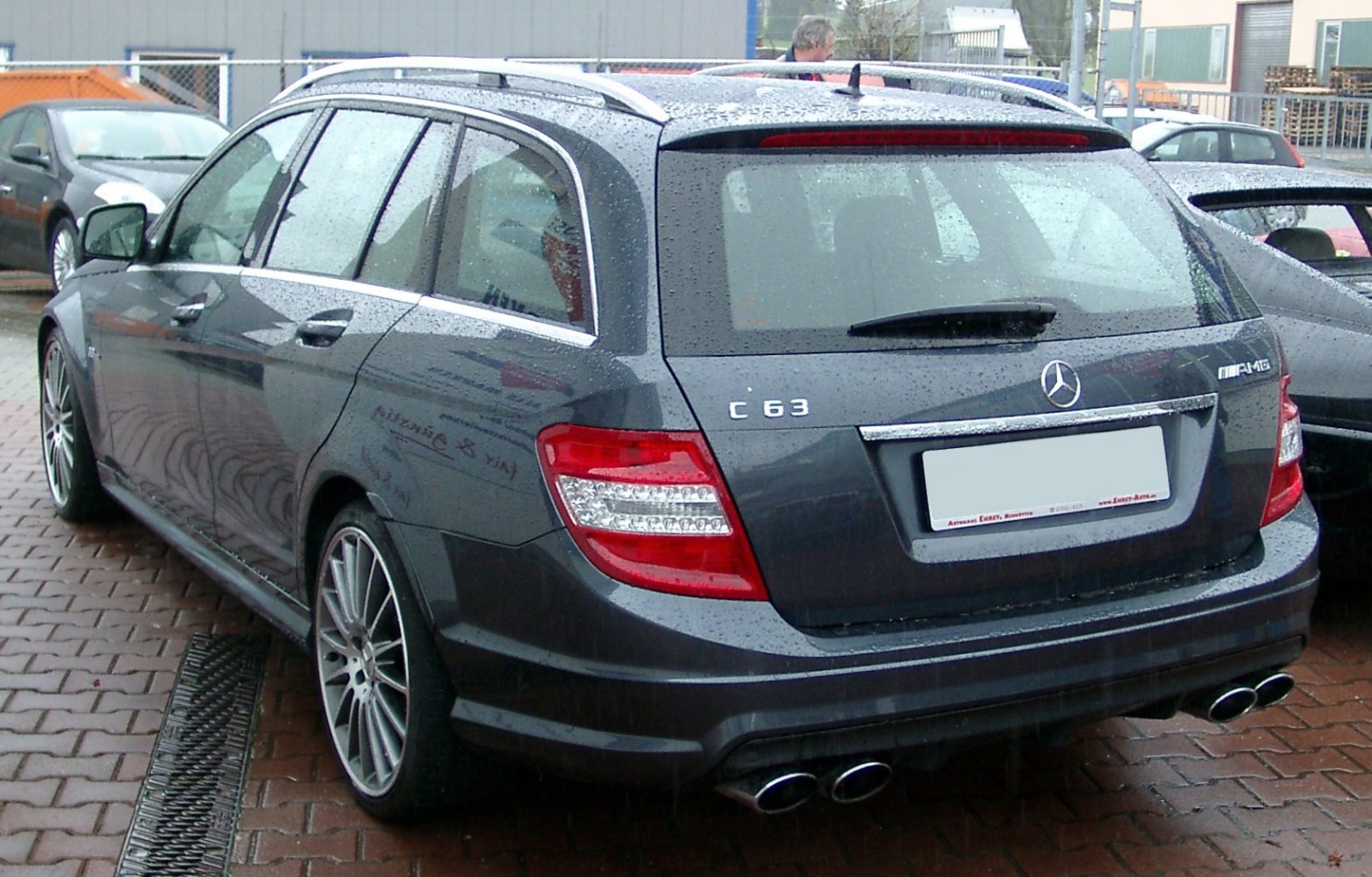 Rear view of wagon with quad exhaust and LED taillights in rain