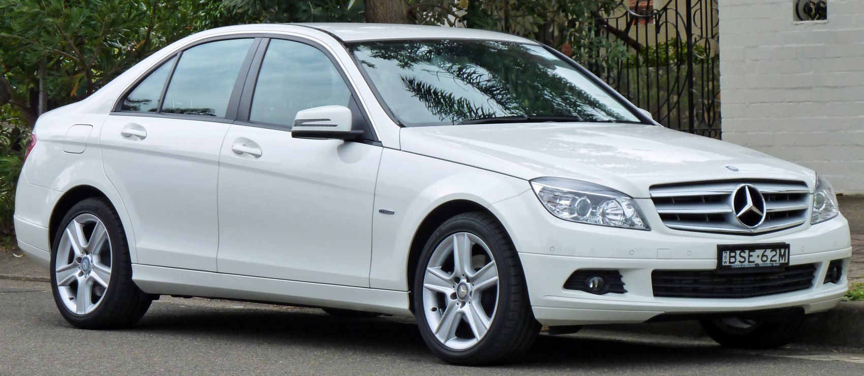 Front side view of a sedan with alloy wheels and clear headlights