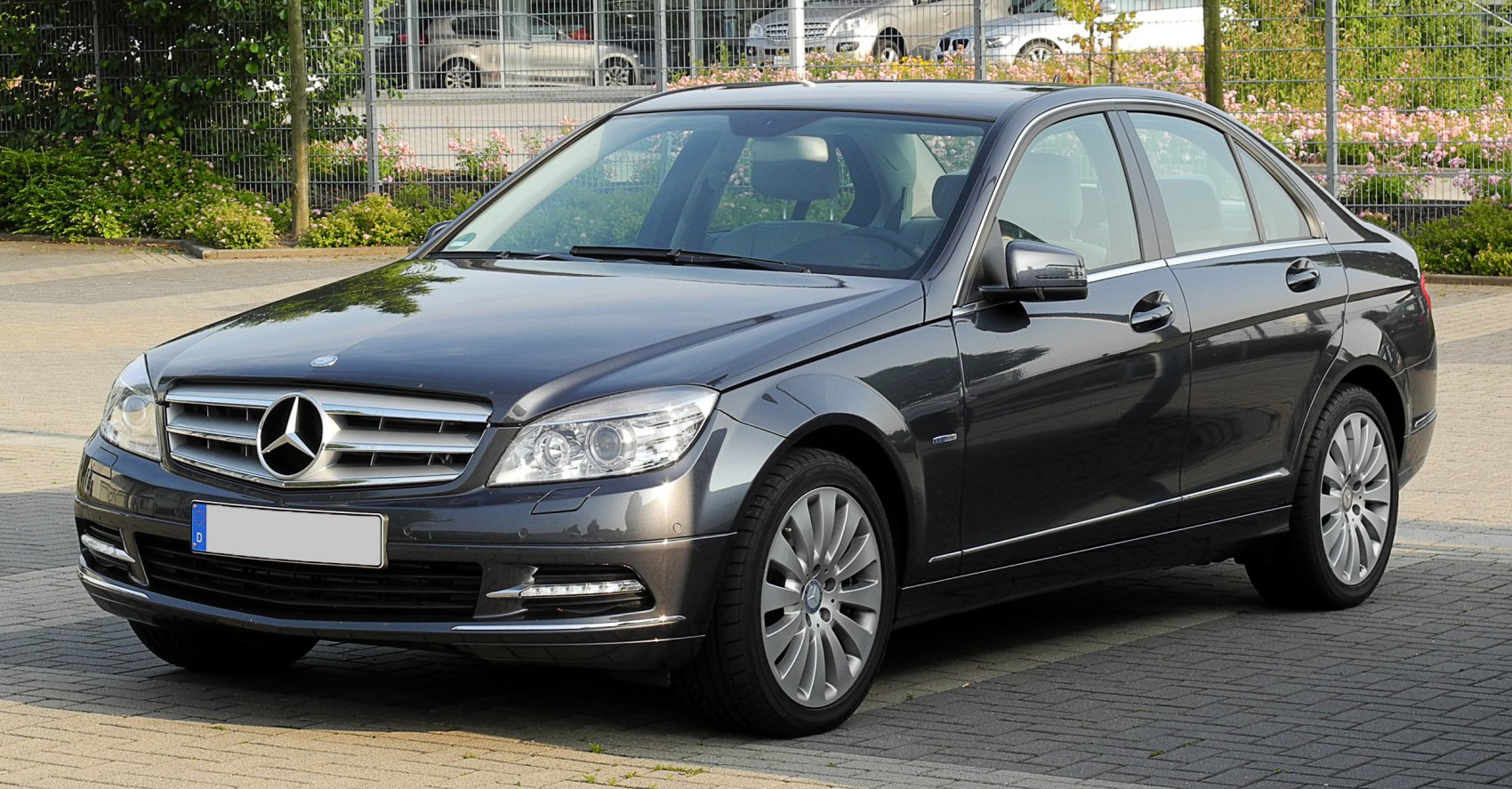 Luxury sedan front and side view with grille and alloy wheels