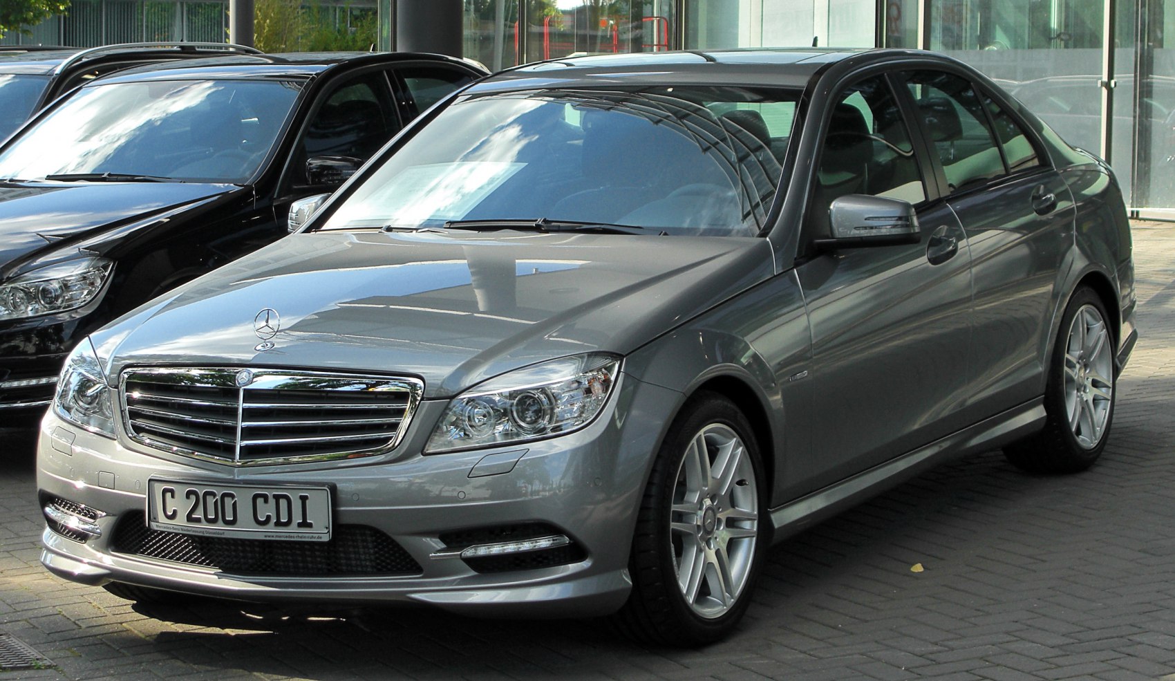 Luxury sedan front view with chrome grille and alloy wheels