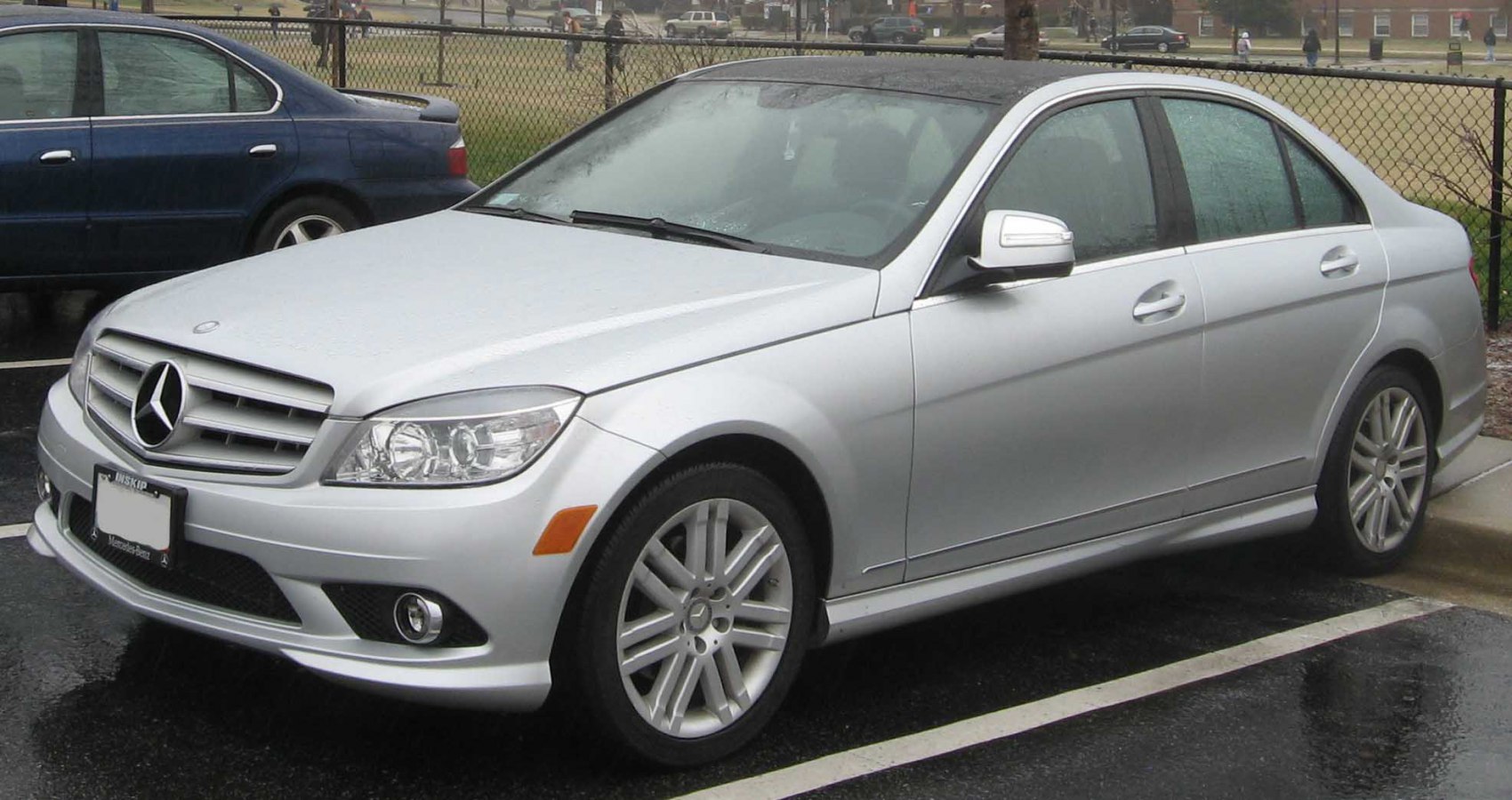 Silver sedan with alloy wheels and front left view in parking lot