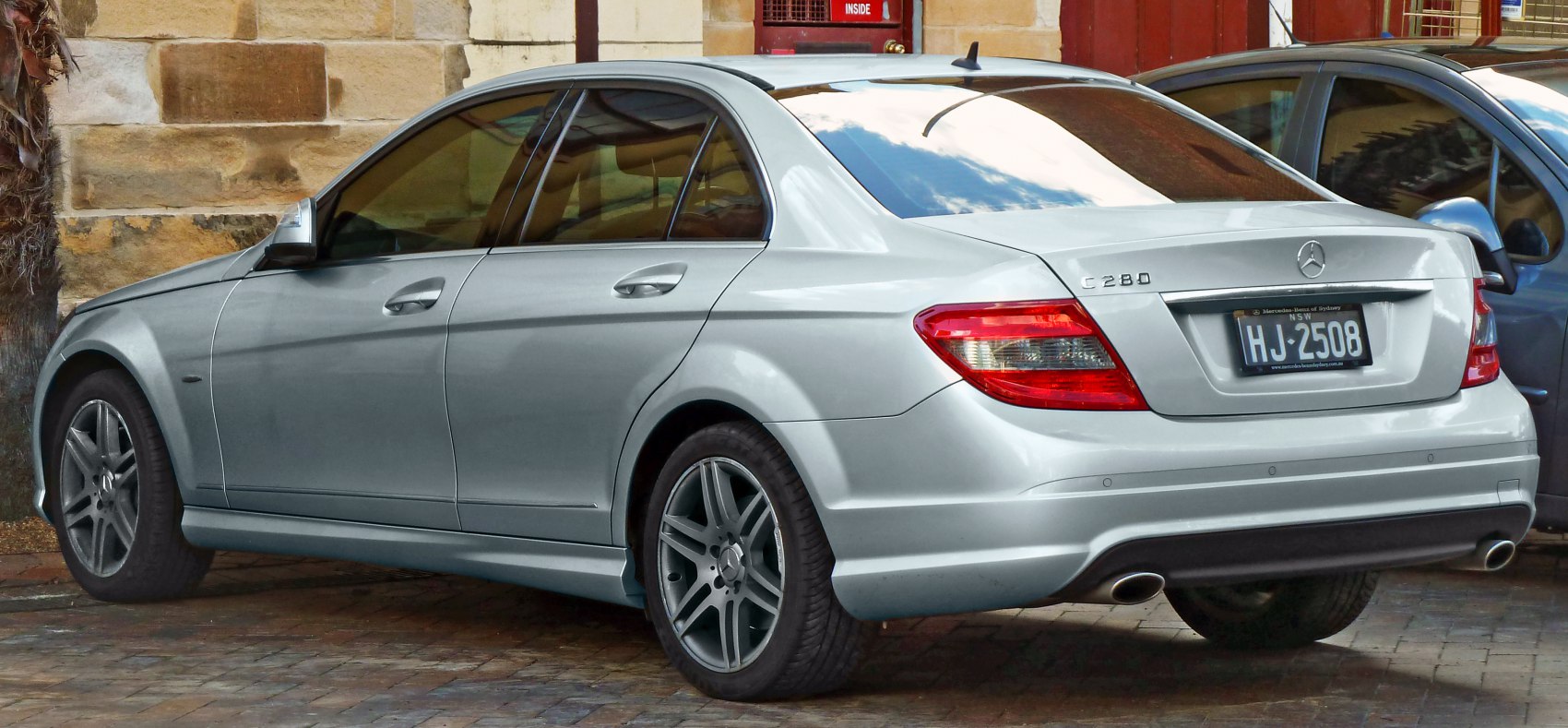 Rear angle of silver luxury sedan with dual exhaust and taillights